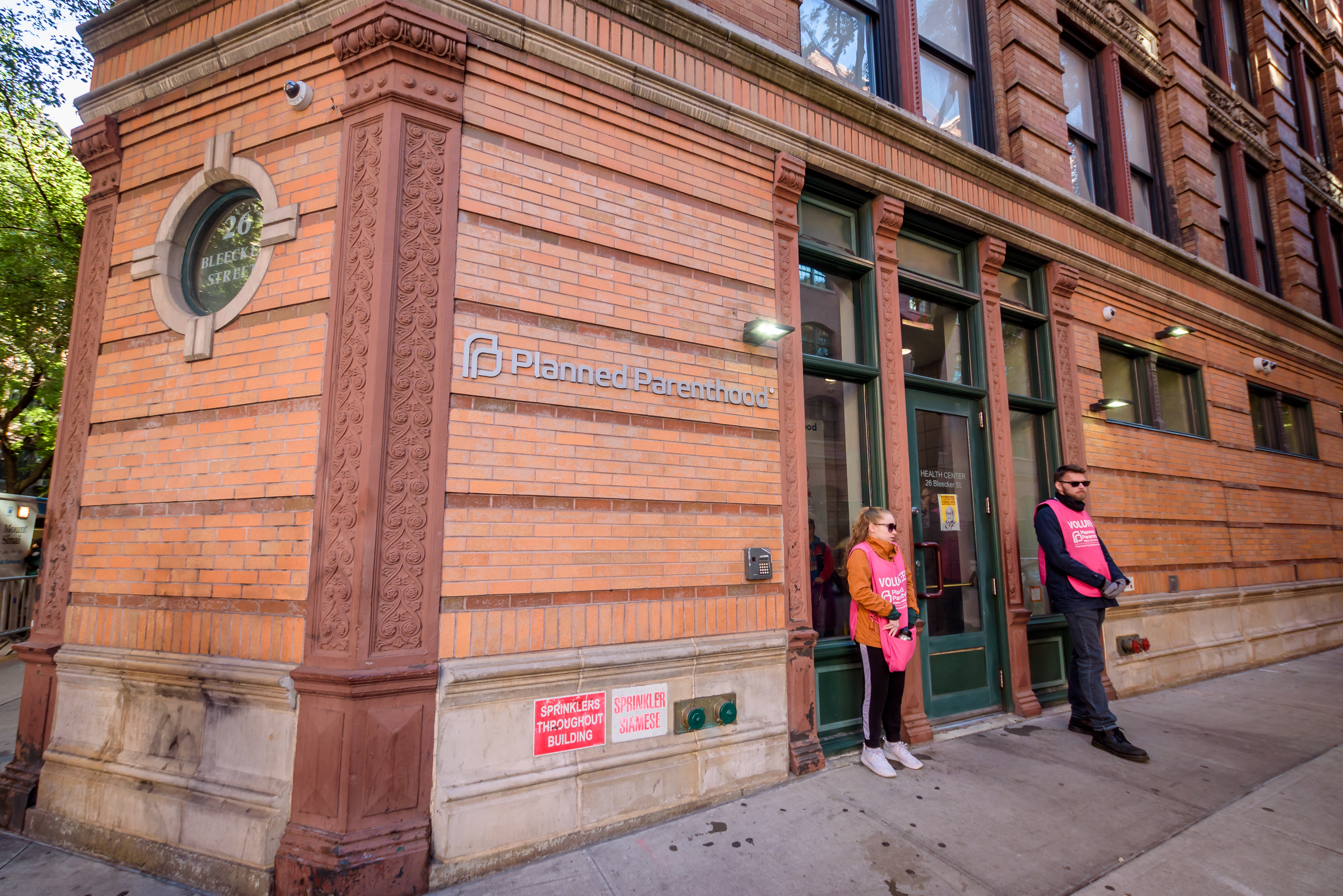 Two volunteers standing at the door of the Planned