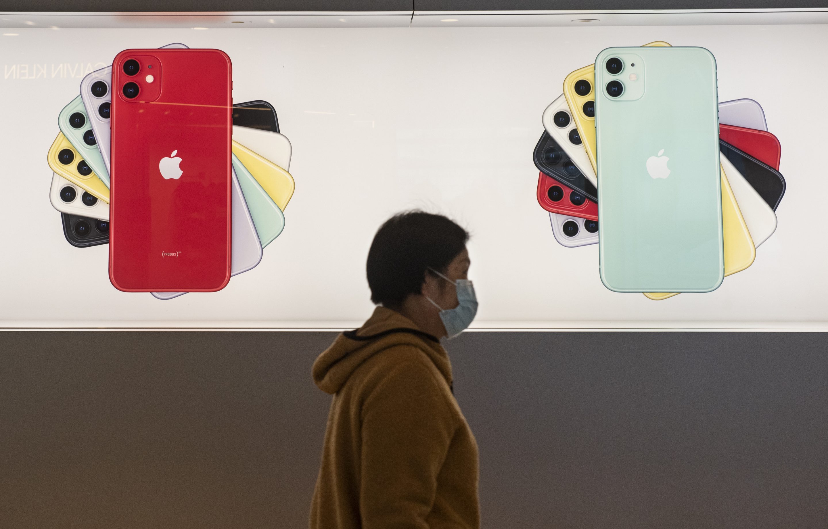 HONG KONG, CHINA - FEBRUARY 14, 2020:
A shopper walks past the American multinational technology company Apple store displaying Iphone banners at its entrance in Hong Kong.-  Budrul Chukrut—Echoes Wire/Barcroft Media/Getty Images