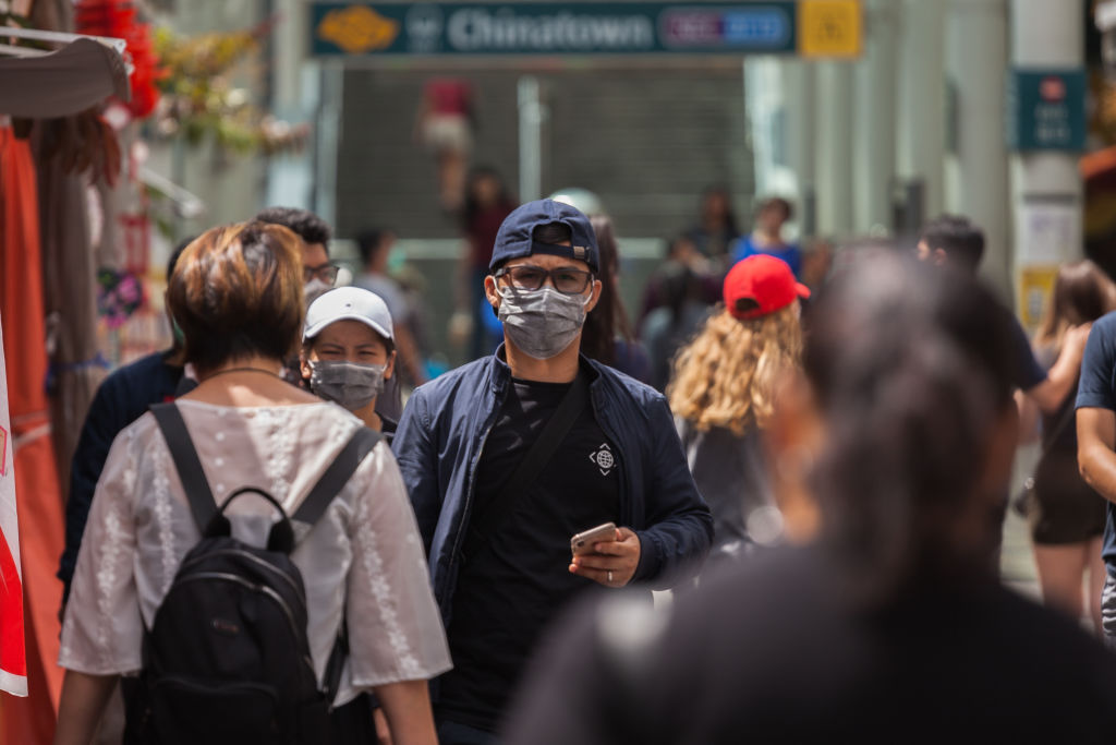 SINGAPORE - FEBRUARY 19, 2020:
A man wearing a protective face masks walks along Chinatown in Singapore.
Singapore declared the COVID-19 outbreak as Code Orange on February 7, 2020 following the corona virus threat.- PHOTOGRAPH BY Maverick Asio / Echoes Wire/ Barcroft Media (Photo credit should read Maverick Asio / Echoes Wire/Barcroft Media via Getty Images)