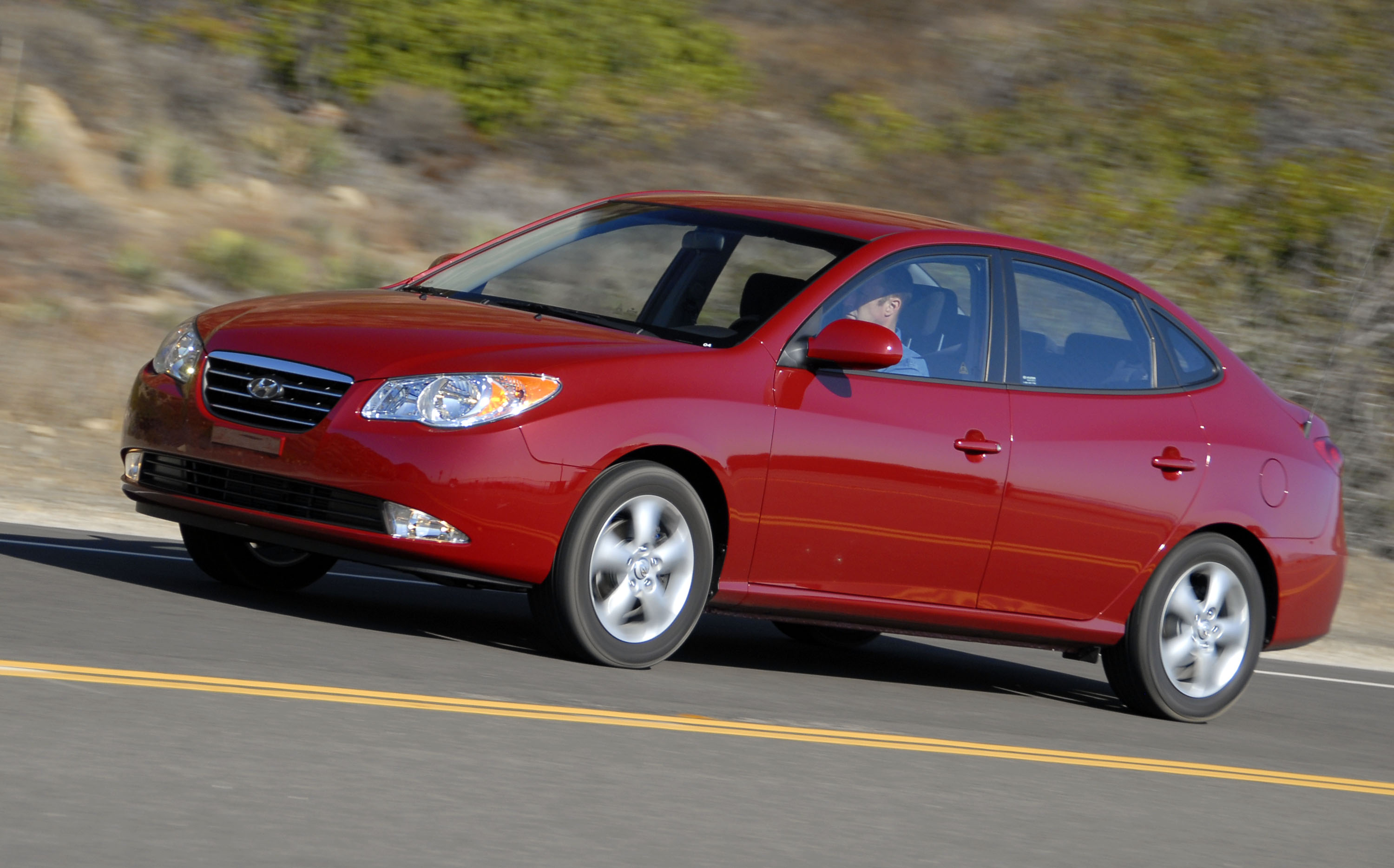 UNITED STATES - OCTOBER 26: Hyundai's 2007 Elantra Sedan is seen at speed on California's Pacific Coast Highway following the firm's introduction of the vehicle to the motoring press in California, on Thursday, October 26, 2006. The four-door, powered by a 138 horsepower 2-liter 4-cylinder engine, features six standard airbags, side-impact airbags, and roof-mounted side curtain airbags for front and outboard rear passengers. Hyundai estimates fuel economy at 28 city, 36 highway for both manual and automatic transmissions. (Photo by Mark Elias/Bloomberg via Getty Images)