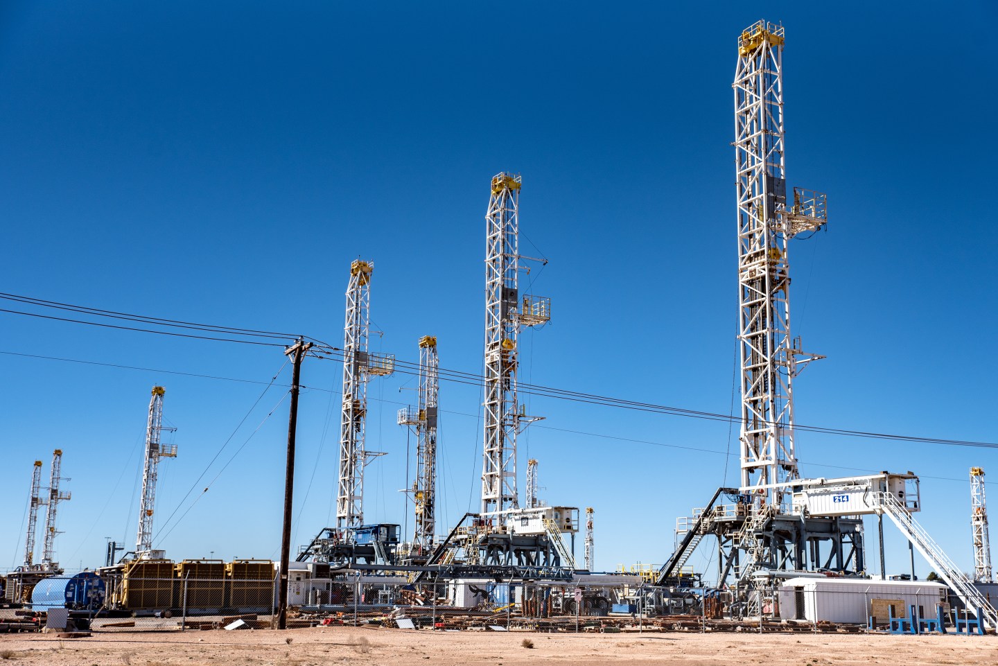 Oil rigs stand in the Permian Basin area of Odessa, Texas, on Jan. 19, 2019. In the Permian, America's busiest oil patch, a producer needs to blast as much as 60,000 barrels of water into a well every day, along with sand and chemicals, to complete the fracking that cracks open the tight, oil-bearing rock about a mile underground.