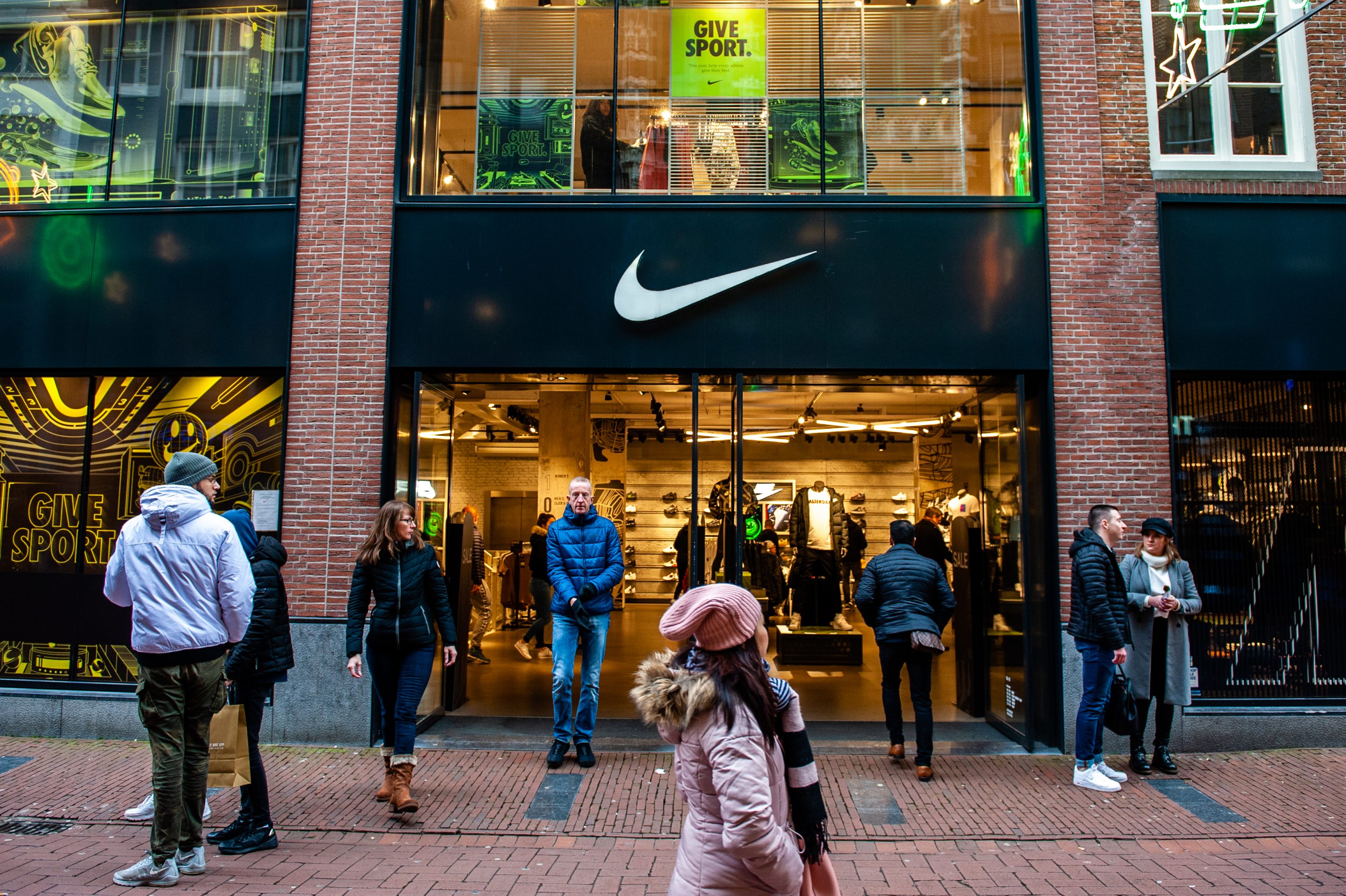 Shoppers walk past the NIKE store in Amsterdam. Ana Fernandez—SOPA Images/LightRocket via Getty Images