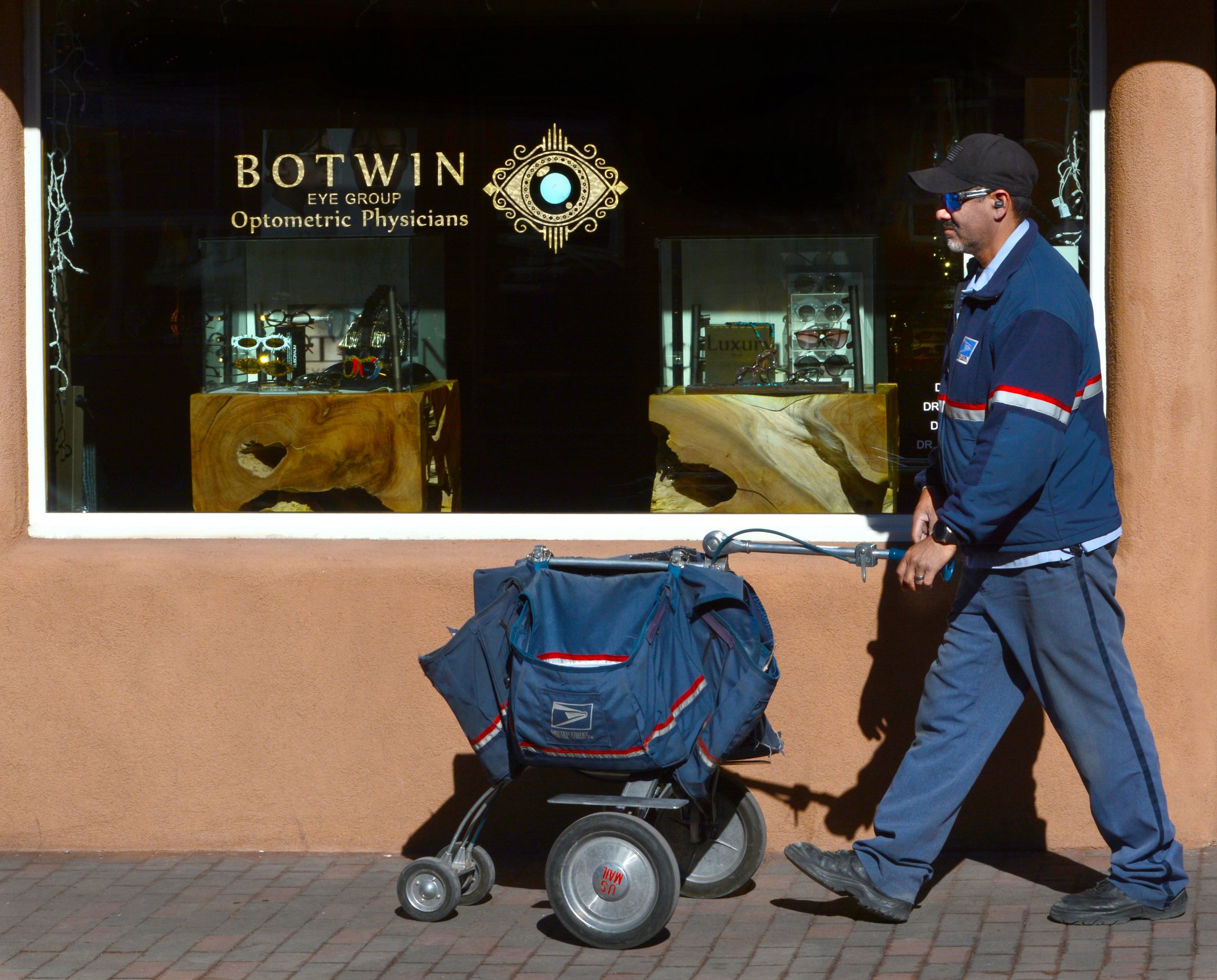 A U.S. Postal Service mailman delivers mail to businesses in downtown Santa Fe, New Mexico.