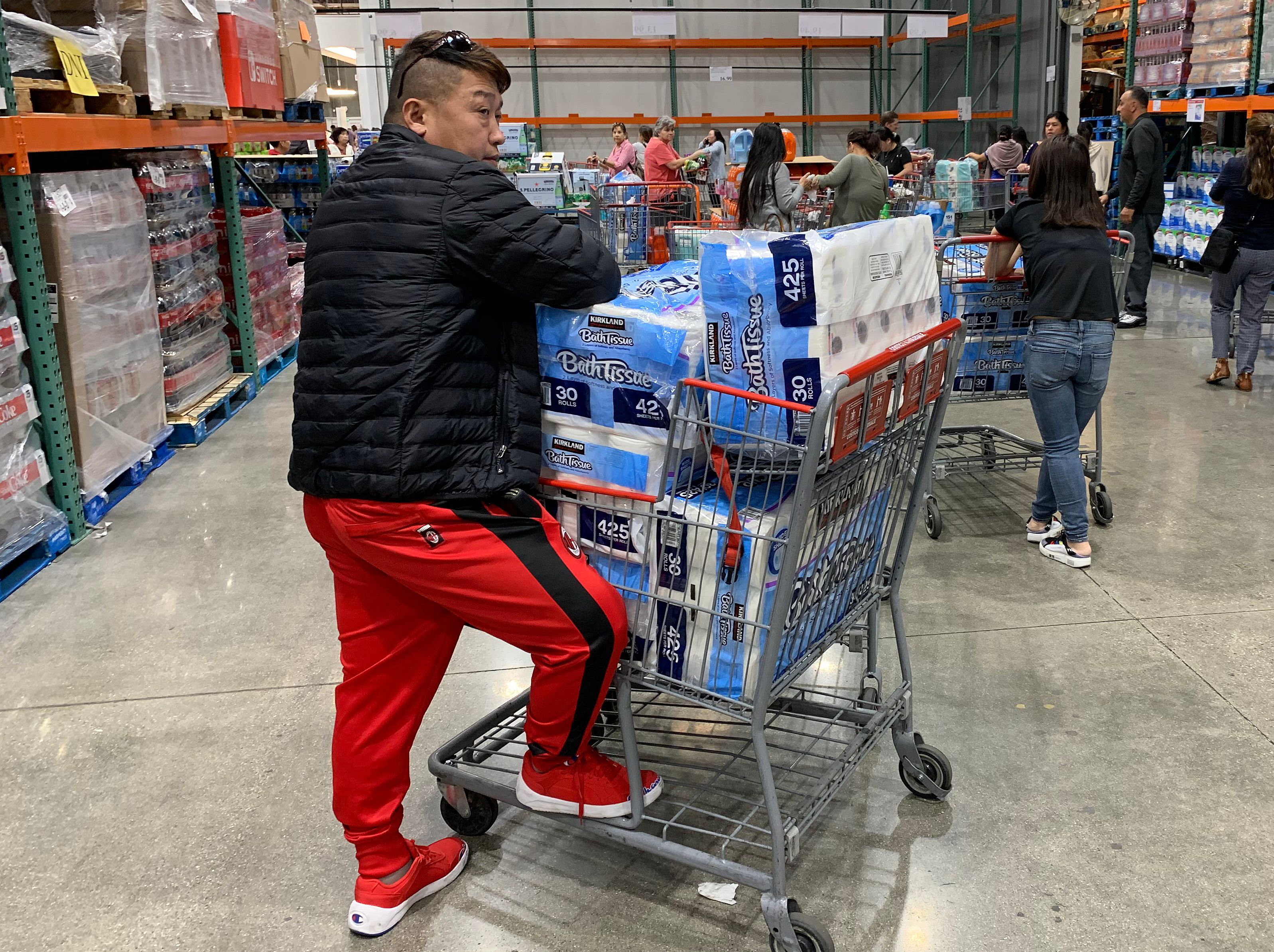 A man prepares to buy 150 rolls of toilet paper at a store, as people begin to panic buy and stockpile essentials from fear that supplies will be affected by the spread of the COVID-19, coronavirus outbreak across the country, in Los Angeles, California on February 29, 2020. The US has suffered its first virus related death as the number of novel coronavirus cases in the world rose to 85,919, including 2,941 deaths, across 61 countries and territories. MARK RALSTON—AFP via Getty Images