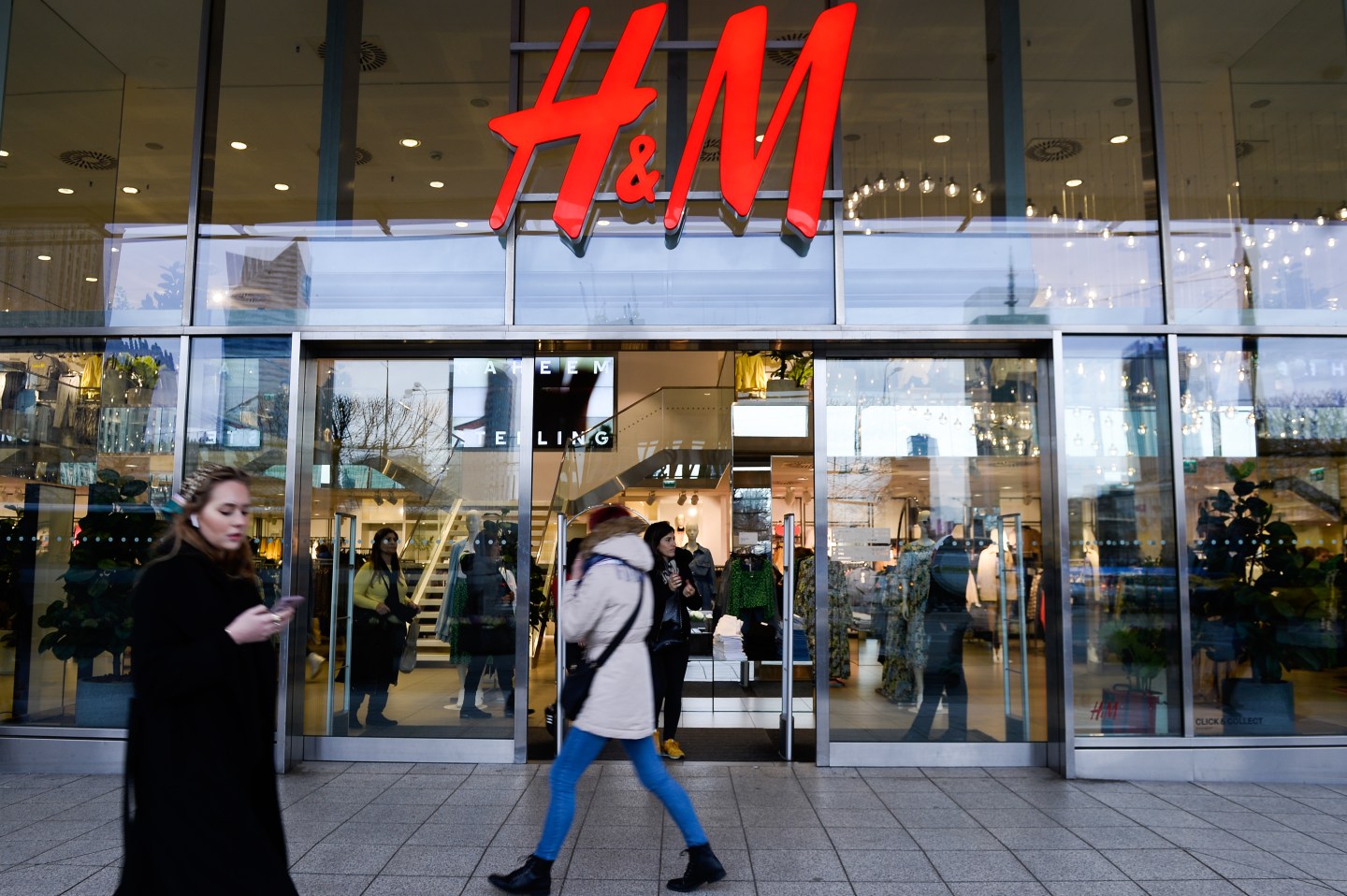 WARSAW, POLAND - 2020/03/03: People walk past a H&M clothing store at the city center.