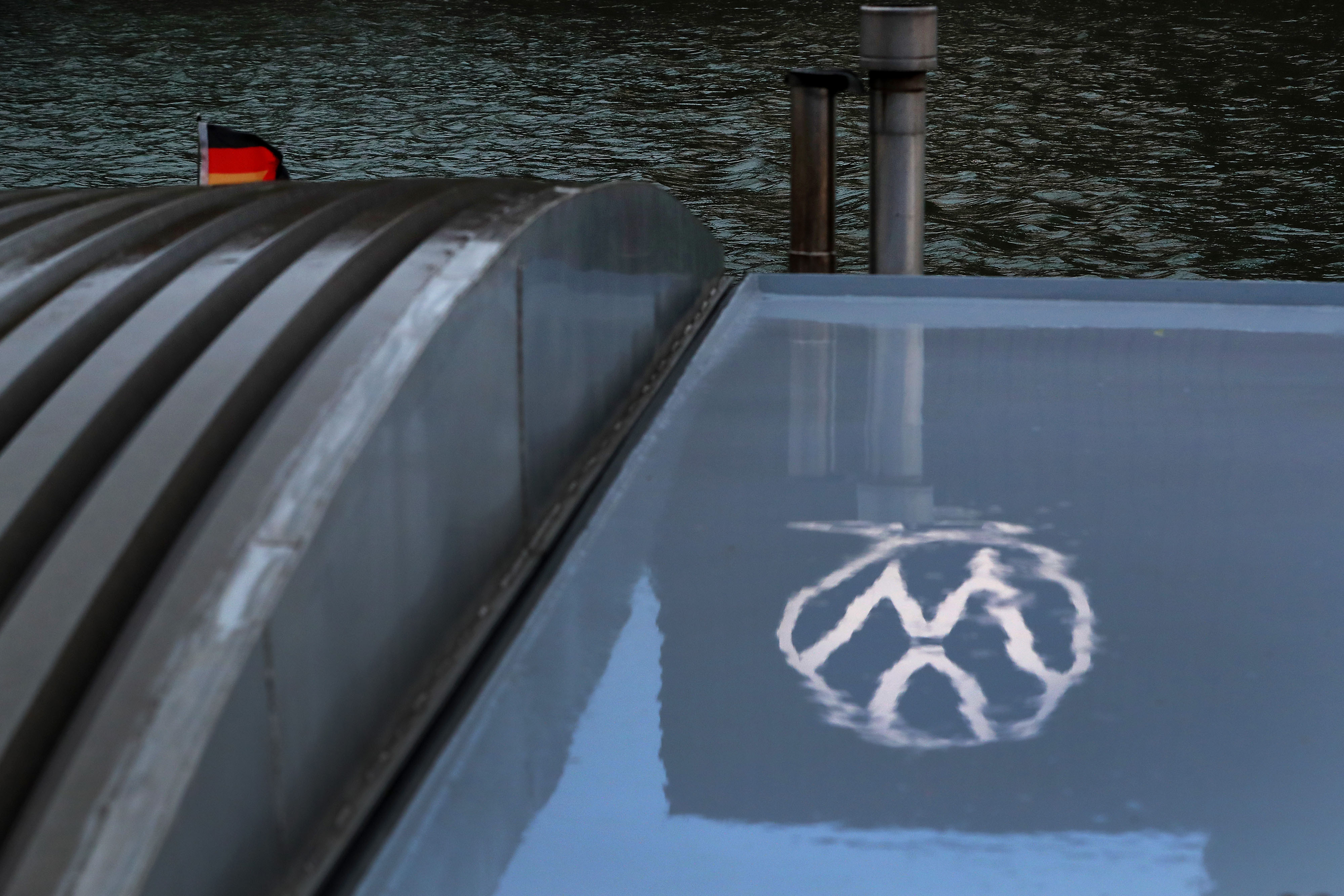 The Volkswagen AG (VW) logo sits reflected on the window of a docked barge on the River Aller in Wolfsburg, Germany, on Thursday, March 12, 2020. The outlook is darkening for everyone from market leader Volkswagen AG to Tesla Inc. and smaller local contenders that were already battling an unprecedented slump before the coronavirus outbreak.