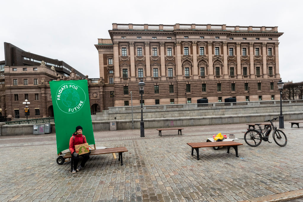 STOCKHOLM, SWEDEN - MARCH 20: A lone climate change protester sits outside of the Swedish parliament building as Stockholm closes down because of the ongoing Covid-19 outbreak on March 20, 2020 in Stockholm, Sweden. The number of cases of Coronavirus in Sweden has risen to 1,456, with 11 Deaths. (Photo by Michael Campanella/Getty Images)