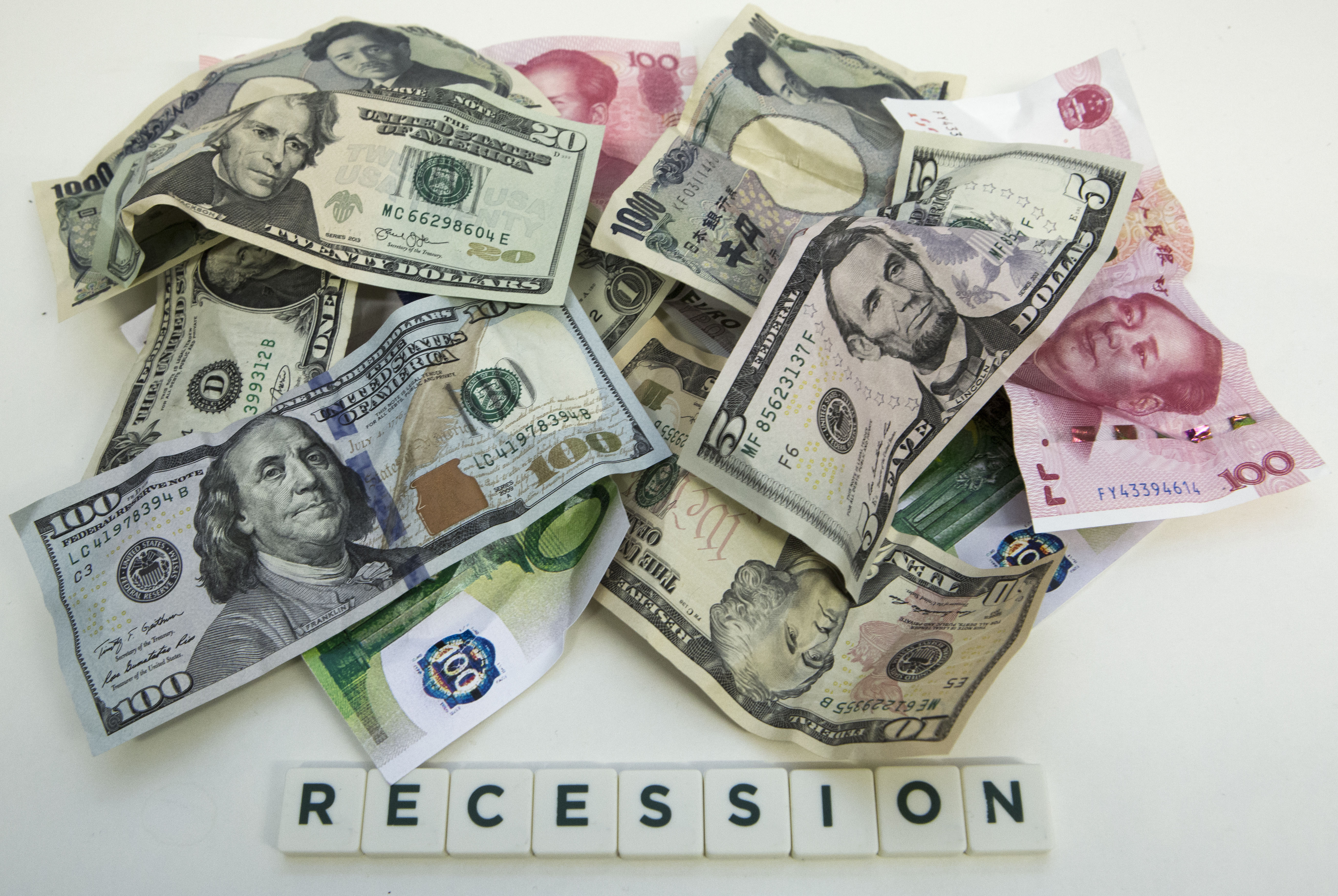 The coronavirus pandemic has nearly shut down the global economy, sending markets in a spiral, driving up unemployment rates and concerns a global recession is near. The photo shows dollar (USA), renminbi (yuan China), yen (Japan) and euro (European Union) banknotes and the lettering recession. Wire photography: Ulrich Baumgarten via Getty Images