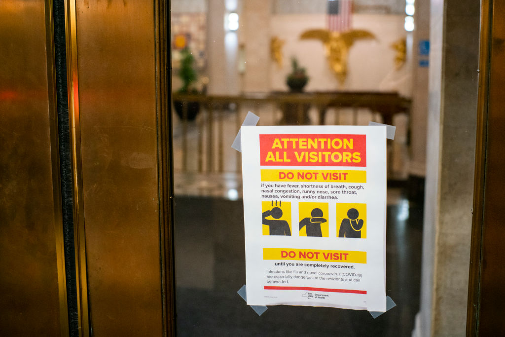 A poster displaying information about the pandemic COVID-19 is seen outside a theater in Times Square after New York cancelled all gatherings over 500 people due to COVID-19 on March 13, 2020 in New York City, NY. President Donald Trump declared a national state of emergency on Friday.