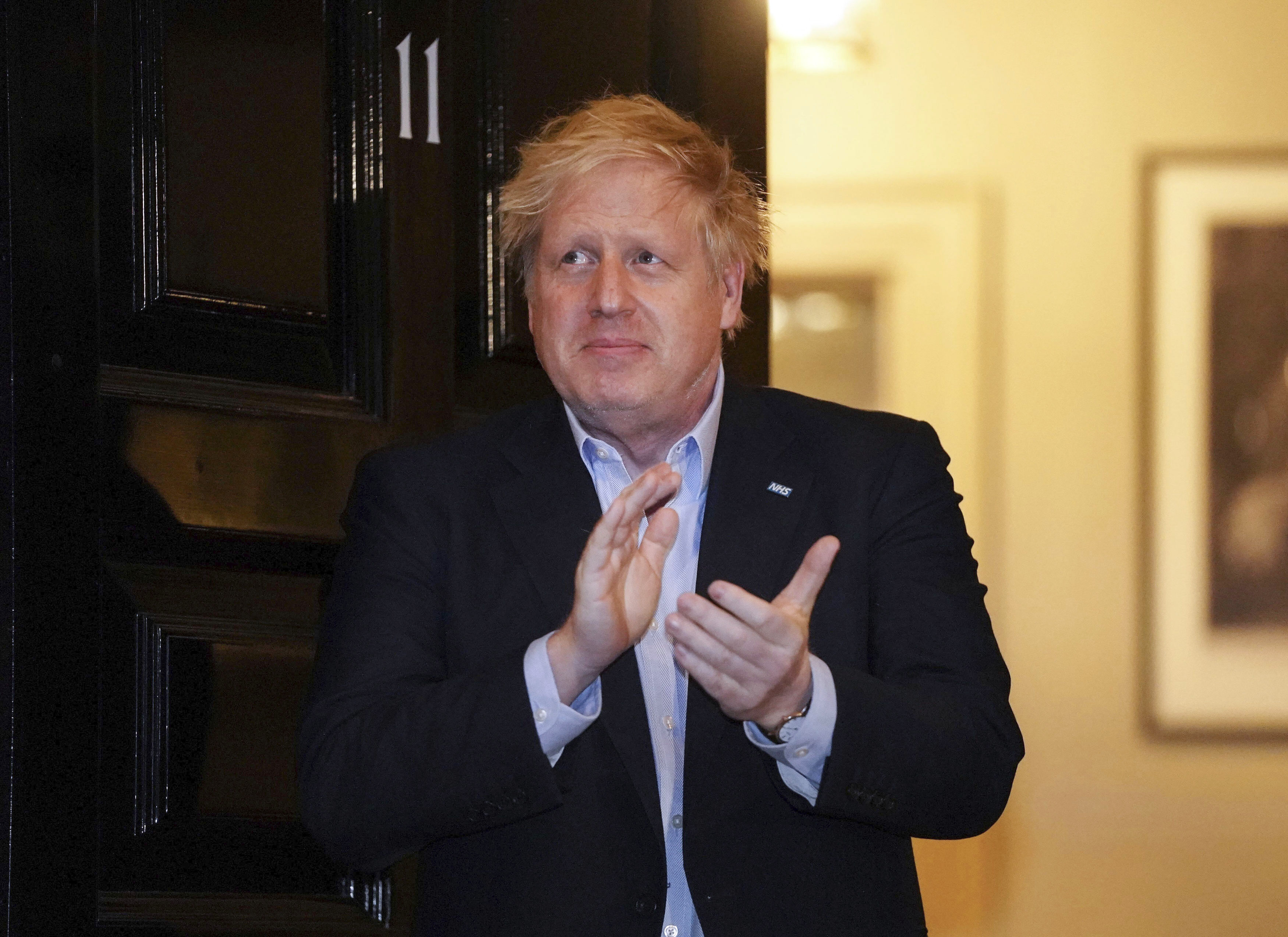 Britain's Prime Minister Boris Johnson claps outside 11 Downing Street to salute local heroes during April 2's nationwide Clap for Carers NHS initiative to applaud workers fighting the coronavirus pandemic, in London. British Prime Minister Boris Johnson has been admitted to a hospital with the coronavirus. Johnson’s office says he is being admitted for tests because he still has symptoms 10 days after testing positive for the virus.Pippa Fowles—10 Downing Street via AP