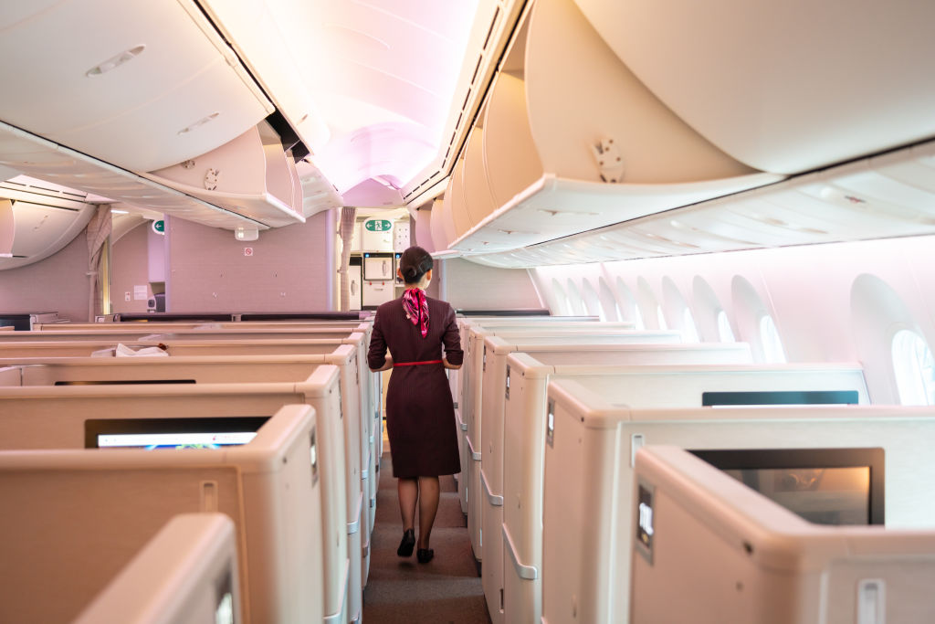 A flight attendant walks in a business cabin of a Shanghai airlines Boeing 787-9 Dreamliner at the Shanghai Hongqiao International Airport.