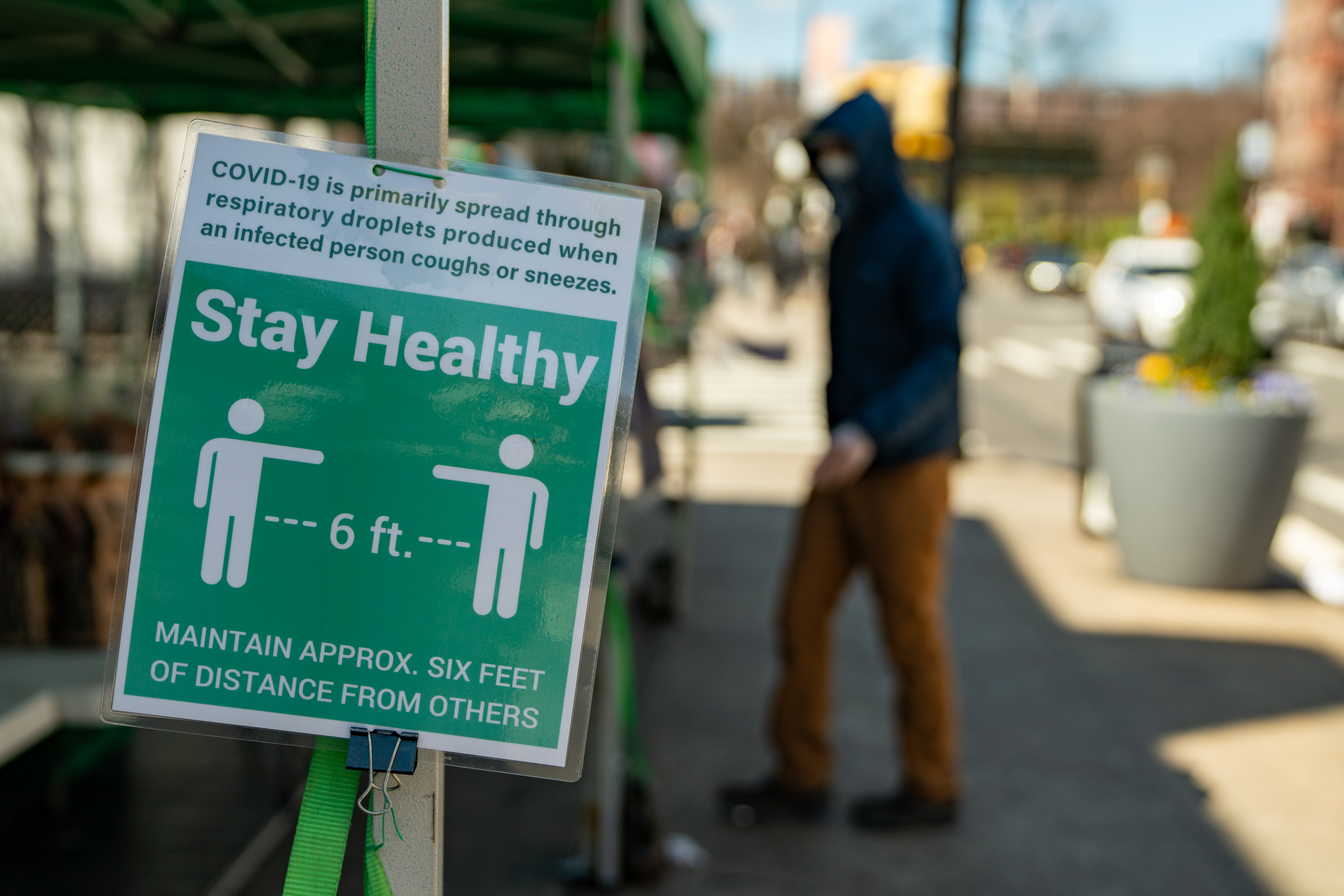 A sign instructs people to stay six feet away at a farmers market in the Bronx borough of New York, U.S., on Thursday, April 2, 2020. The new coronavirus has now infected more than 1 million people and killed more than 53,000 with the U.S. accounting for a quarter of the cases. Wire photography: David Dee Delgado—Bloomberg via Getty Images