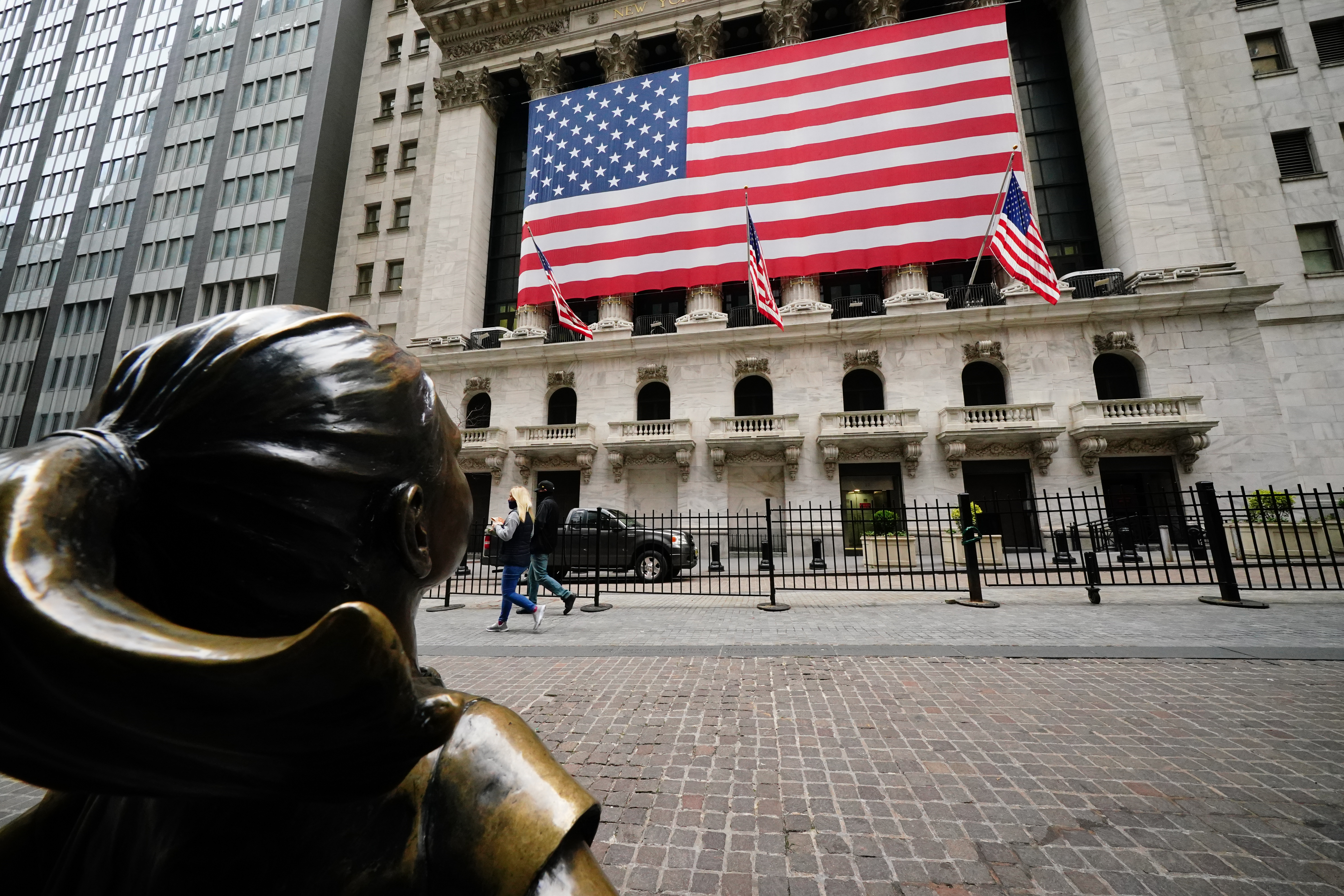 A view of the Fearless Girl with New York Stock Exchange in Wall Street in the backdrop on April 5, 2020. Global equities climbed on Monday as coronavirus concerns subsided somewhat. Wire photography: John Nacion/NurPhoto via Getty Images