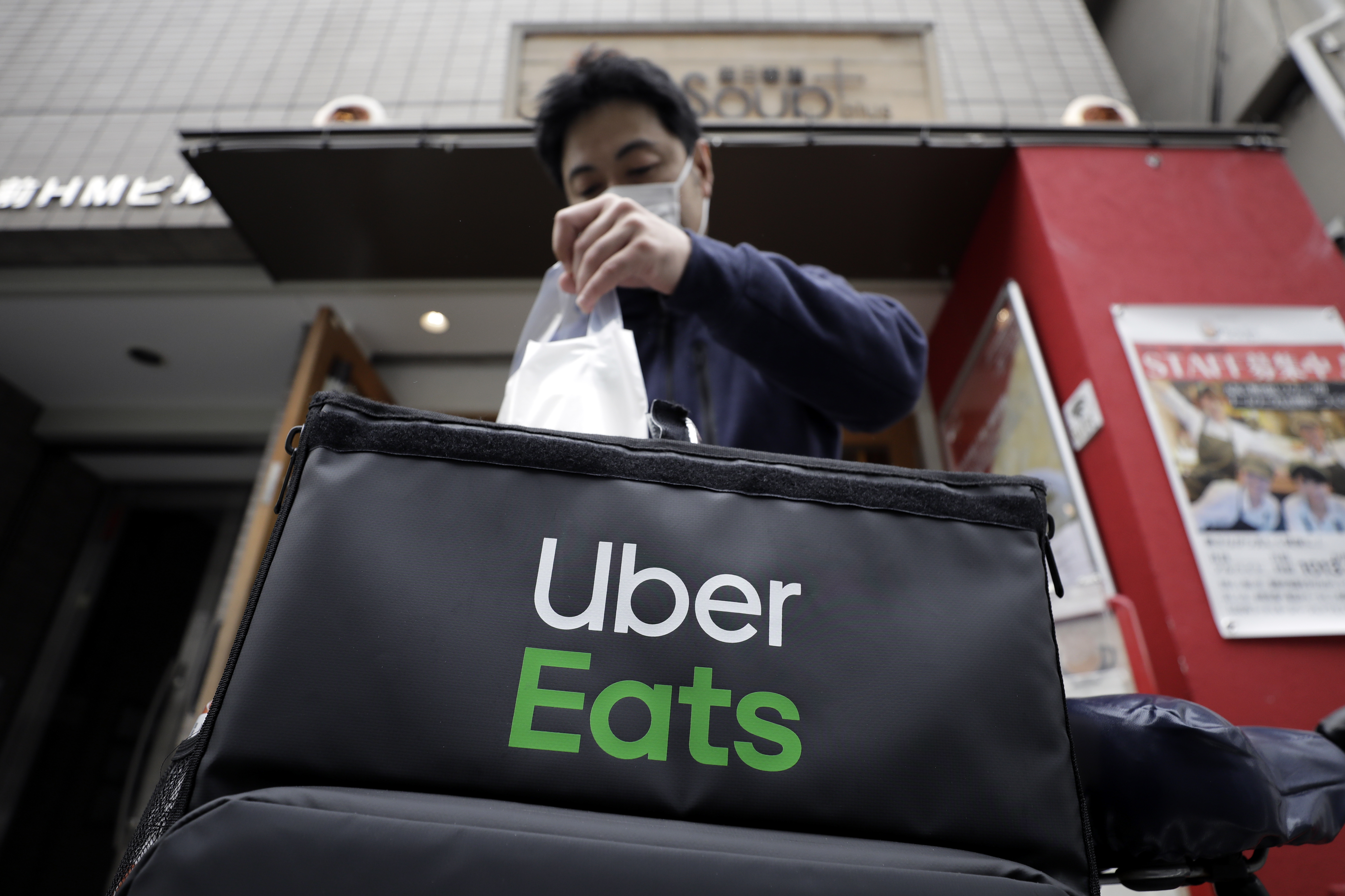 An Uber Eats delivery courier wearing a protective mask Kiyoshi Ota/Bloomberg via Getty Images