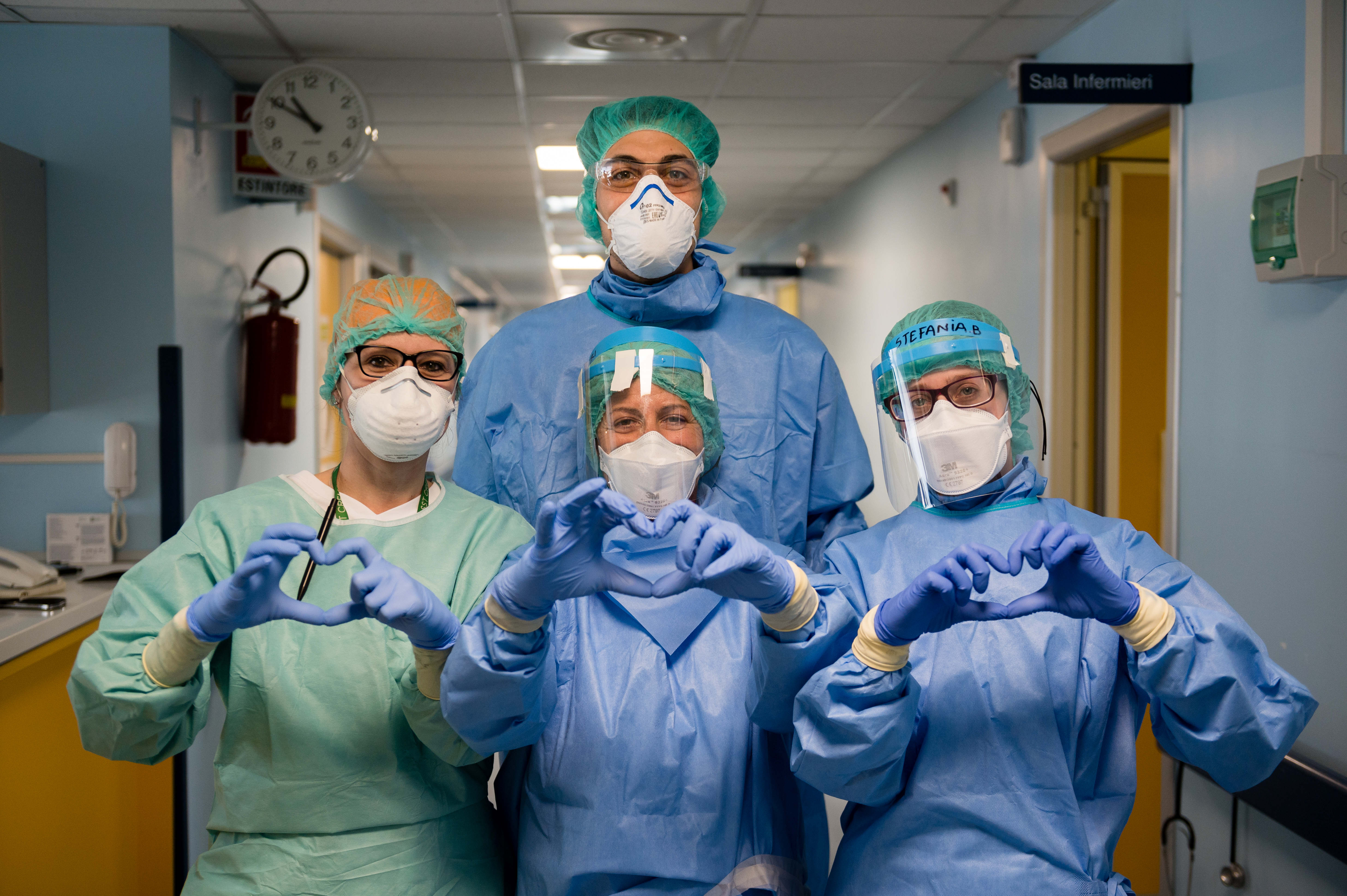 Nurses making the hearth sign at Cremona Hospital on March 29, 2020 in Cremona, Italy. More than 60 Italian doctors and nurses have died from contracting coronavirus. A new technology in use in Italy hopes to speed up detections. Wire photography: Marco Mantovani—Getty Images
