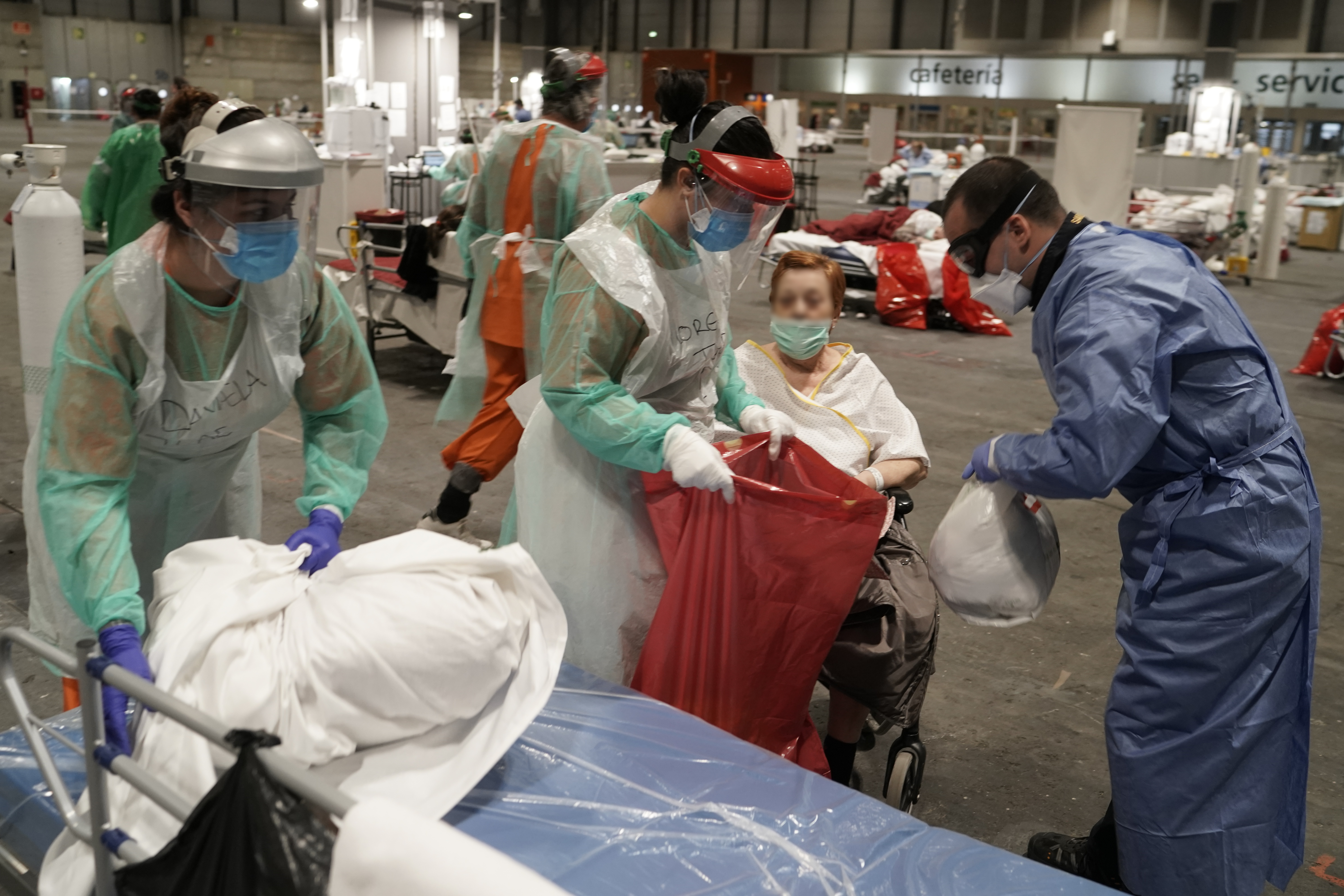 MADRID, SPAIN - MARCH 31: In this handout picture provided by Comunidad de Madrid, patients are seen being transferred from Pavilion 5 to Pavilions 7 and 9 at Emergency Hospital IFEMA on March 31, 2020 in Madrid, Spain. Spain ordered all non-essential workers to stay home for two weeks to help slow the Coronavirus (COVID-19) pandemic, which has killed more than 6,000 people in the country. (Photo by Borja sanchez-trillo - Comunidad de Madrid - Handout/Getty Images)