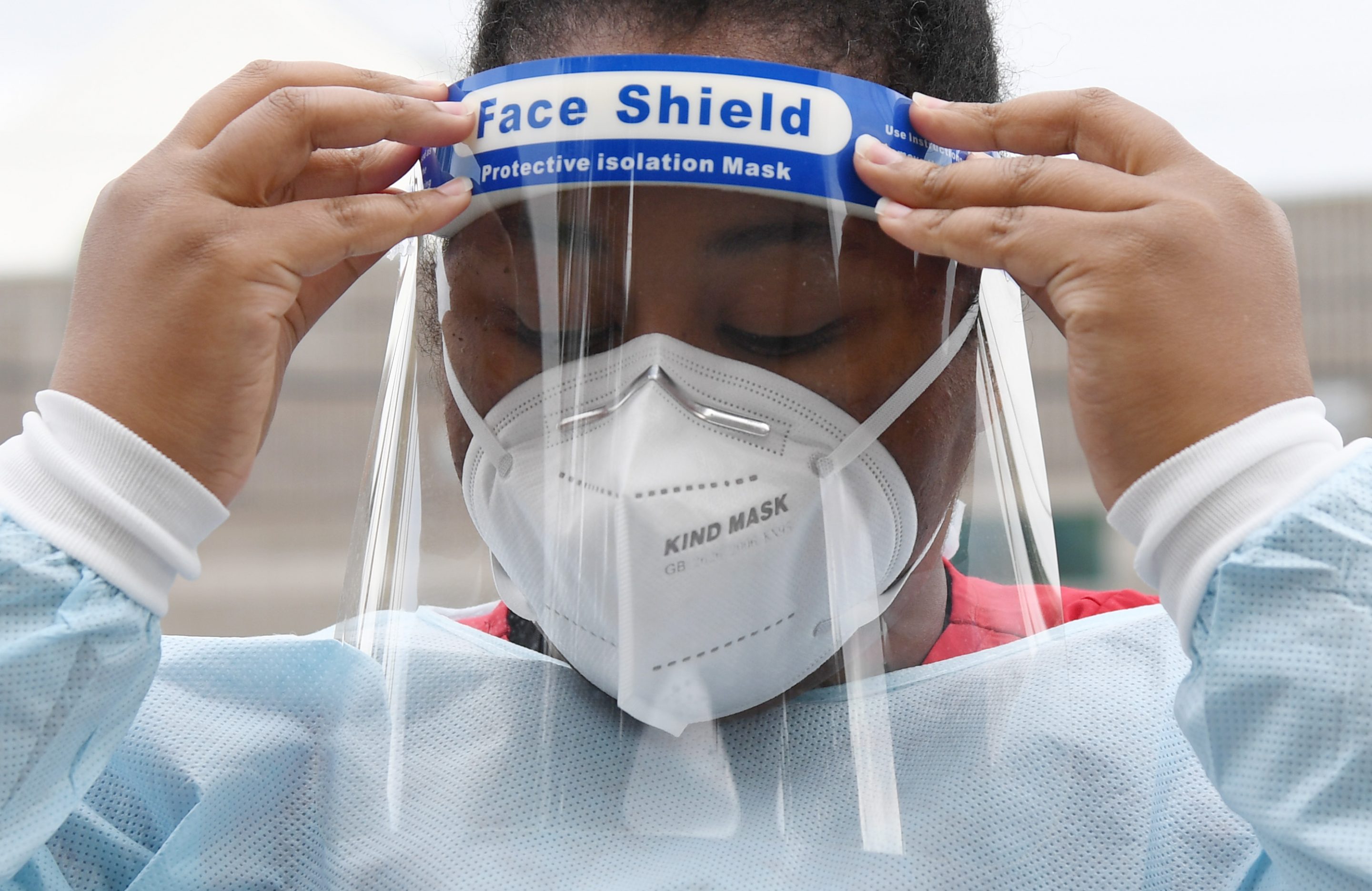 LAS VEGAS, NEVADA - APRIL 06: Certified medical assistant Lakietha Flournoy puts on personal protective equipment as she gets ready to conduct tests for COVID-19 at a drive-up testing station in the parking lot of UNLV Medicine on April 6, 2020 in Las Vegas, Nevada. UNLV Medicine, the clinical arm of the UNLV School of Medicine, has tested more than 2,000 pre-screened people since beginning its free curbside testing operation on March 23rd, but currently has only enough test kits to continue through tomorrow due to the national shortage of kits. The school will continue or restart testing if it is able to procure more kits. The World Health Organization declared the coronavirus (COVID-19) a global pandemic on March 11th.