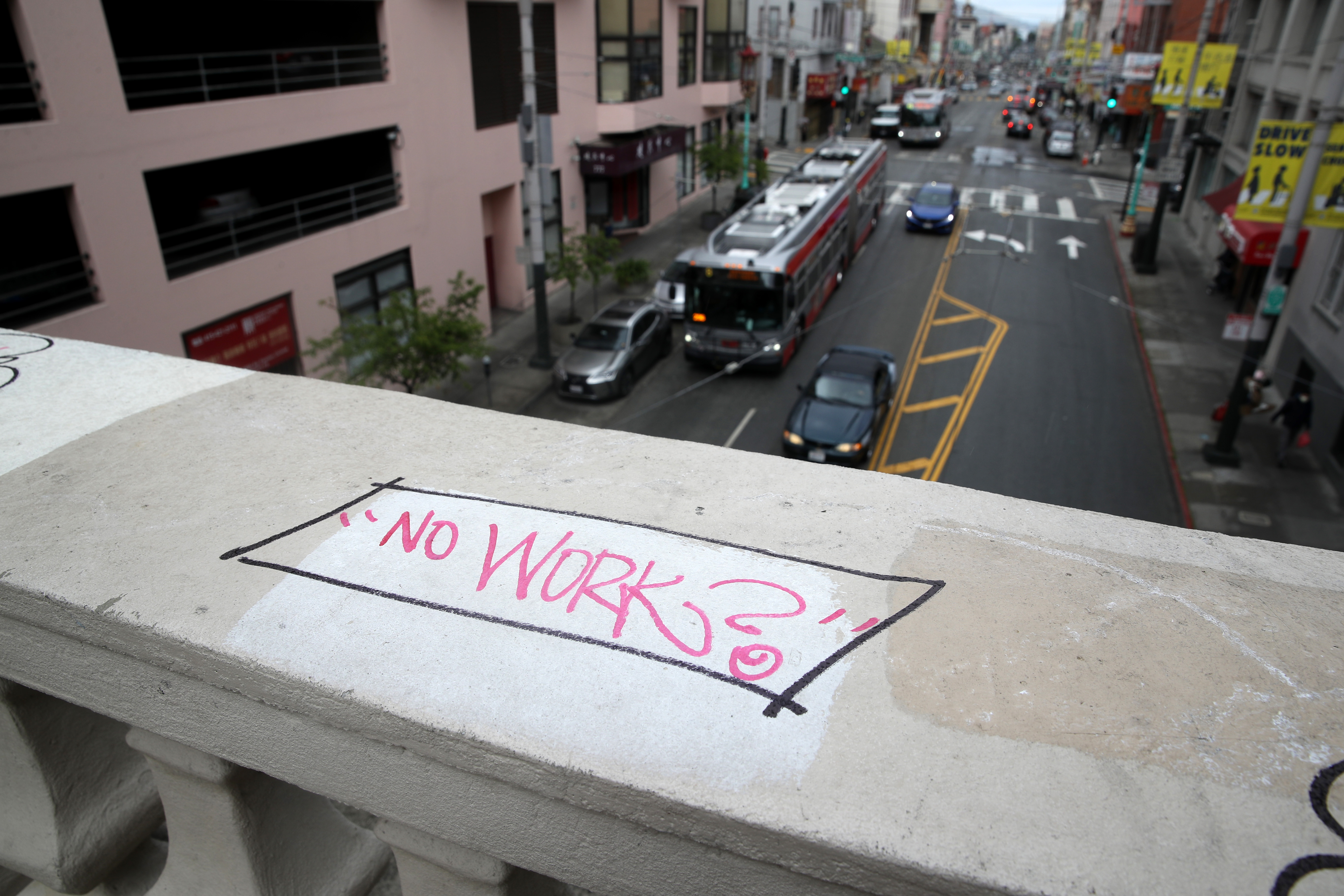 Graffiti is written on a bridge above a San Francisco MUNI bus travelling along Stockton Street in San Francisco, California. All eyes are on Thursday's weekly jobless claims report, which will reveal how bad the unemployment raate could get amid the coronavirus crisis. (Photo by Justin Sullivan/Getty Images)