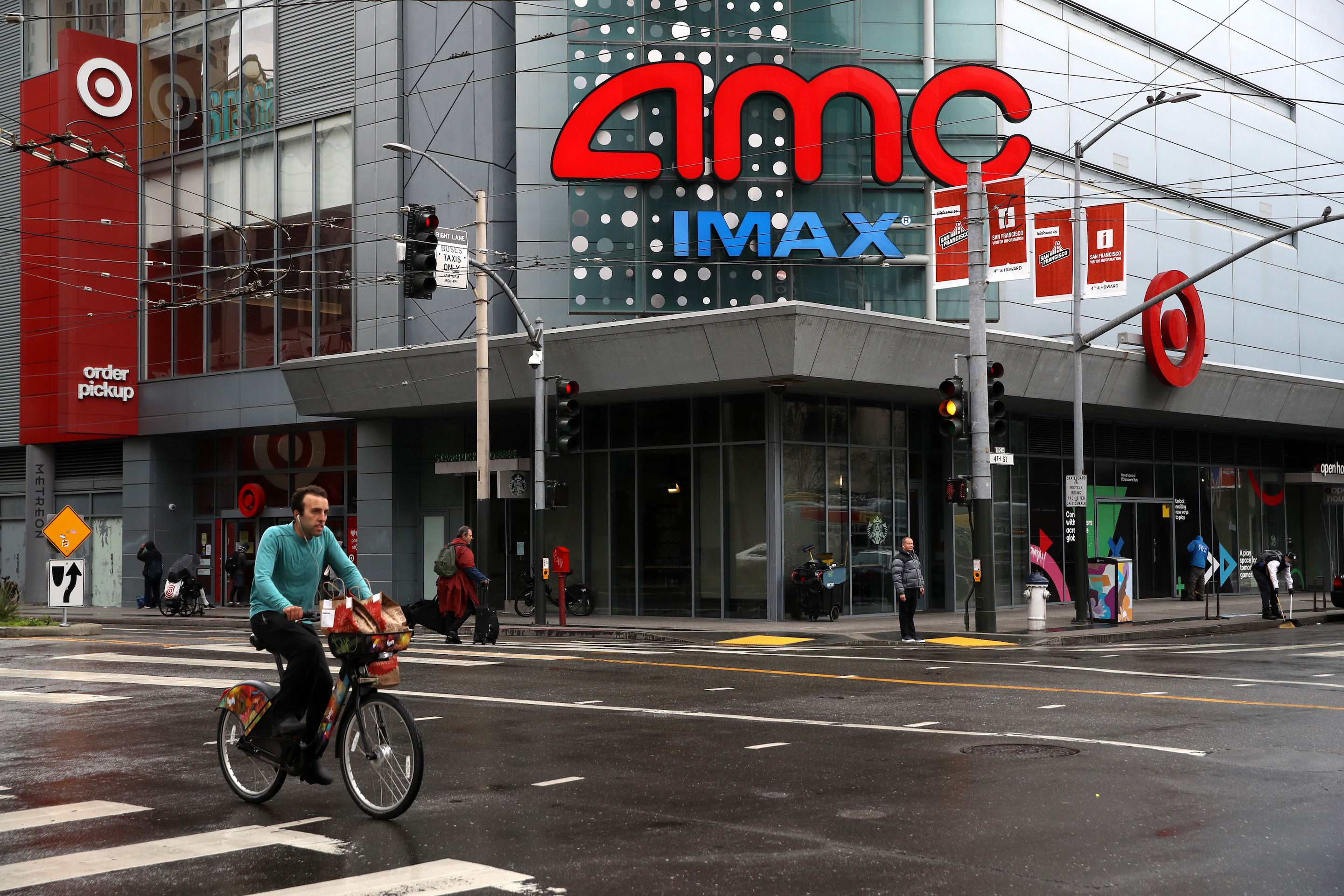 A cyclist rides his bike by an AMC theater during the coronavirus (COVID-19) pandemic on April 6 in San Francisco. The future of AMC remains in question after it shuttered all of its theaters and furloughed its corporate staff. Justin Sullivan—Getty Images