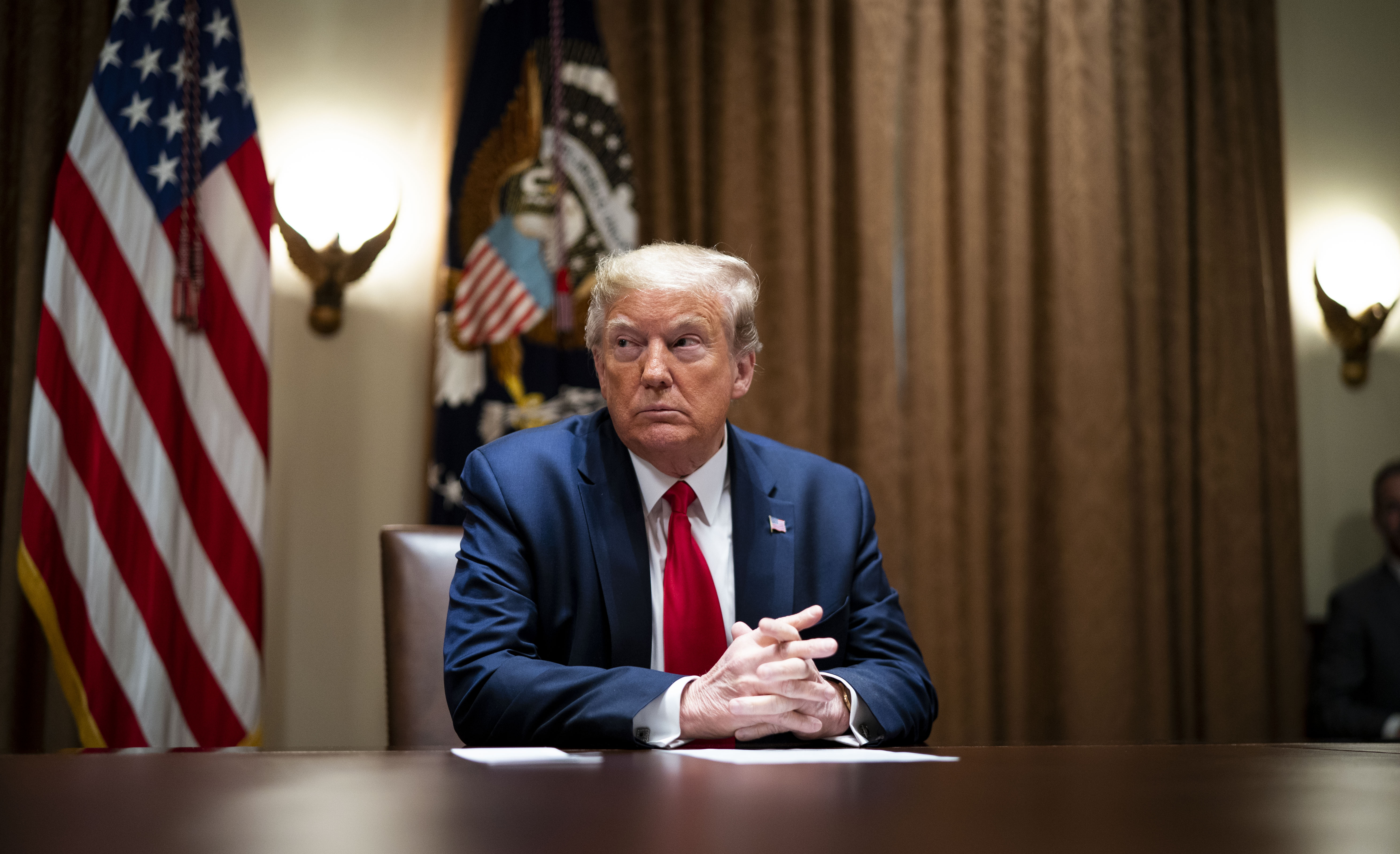 WASHINGTON, DC - APRIL 14: President Donald Trump listens during a meeting with healthcare executives in the Cabinet Room of the White House April 14, 2020 in Washington, D.C. Earlier in the day Trump met with people who had recovered from the coronavirus. During the April 13 Coronavirus Task Force briefing, Trump said the president had "total authority" to reopen the U.S. economy. (Photo by Doug Mills-Pool/Getty Images)