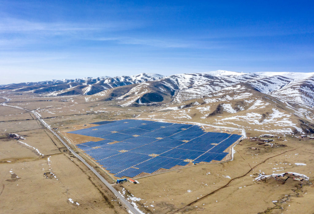 ABA, CHINA - APRIL 25: Aerial view of solar panels at a photovoltaic power station with snow mountains in the background on April 25, 2020 in Aba County, Sichuan Province of China. (Photo by Liu Guoxing/VCG via Getty Images)