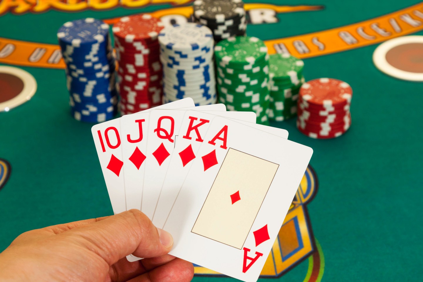 Poker hand in front of a stack of chips