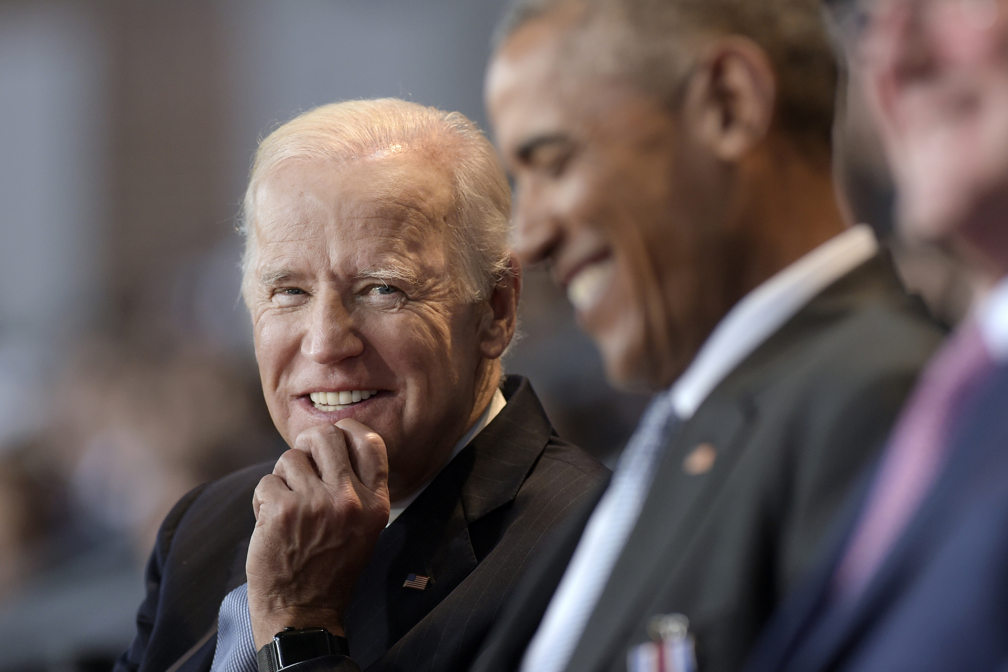 Vice President Joe Biden, left, watches President Barack Obama, center, in 2017. 