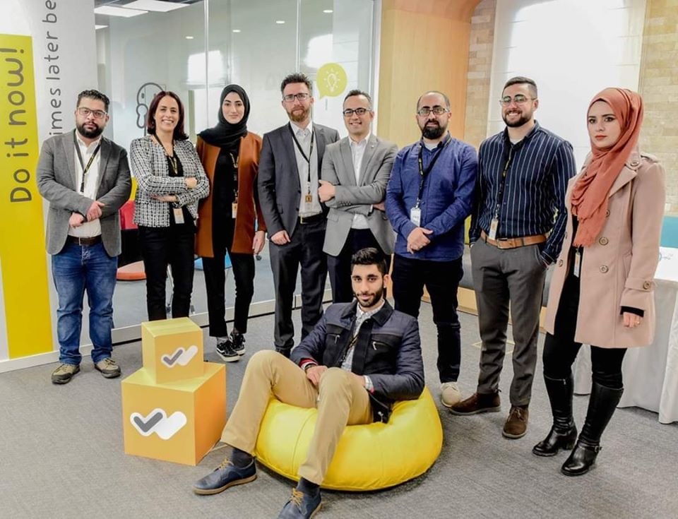 Ahmad Ramahi, the founding CEO of WeDeliver (fourth from the right) with employees in his company's office.