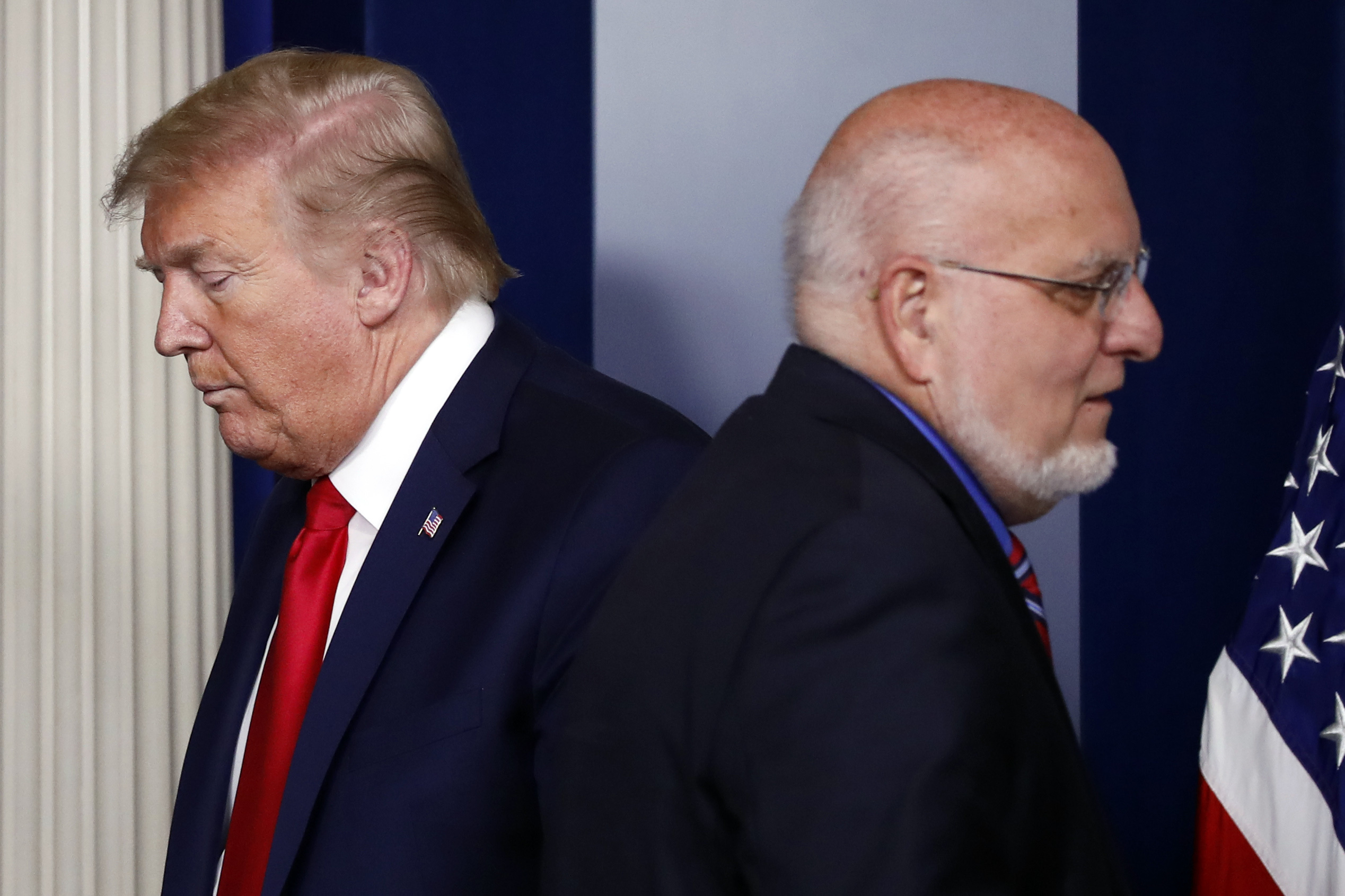 President Donald Trump passes Dr. Robert Redfield, director of the Centers for Disease Control and Prevention, during a briefing about the coronavirus in the James Brady Press Briefing Room of the White House. Alex Brandon—AP Photo