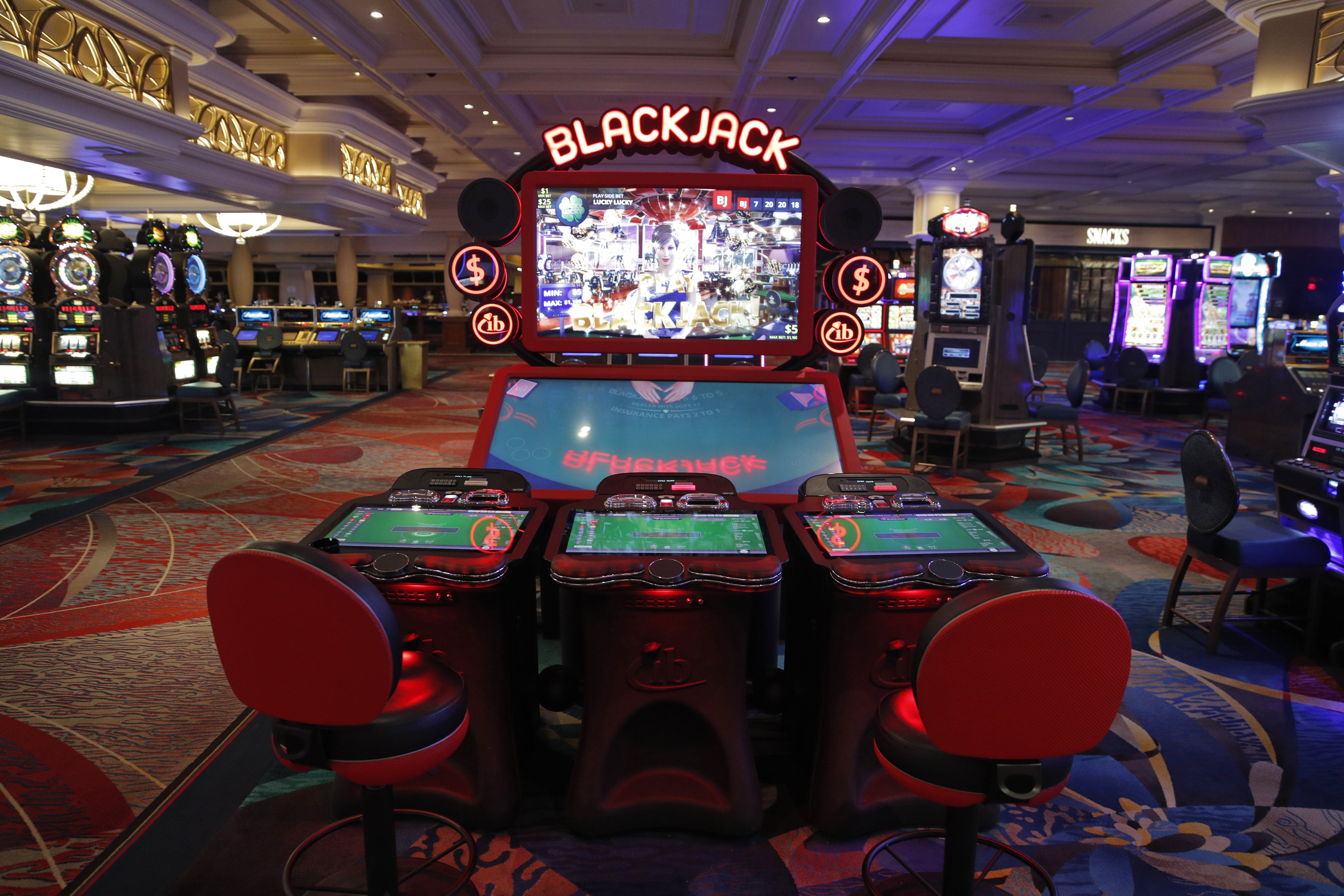 Chairs are removed to keep social distancing between players as a coronavirus safety precaution at an electronic gaming machine in the closed Bellagio hotel and casino, Wednesday, May 20, 2020, in Las Vegas. Casino operators in Las Vegas are awaiting word when they will be able to reopen after a shutdown during the coronavirus outbreak.