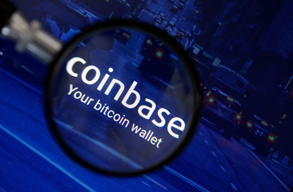 PARIS, FRANCE - OCTOBER 05:  In this photo illustration, the Coinbase cryptocurrency exchange logo is seen magnified on the screen of a tablet on October 05, 2018 in Paris, France. The California cryptocurrency platform is about to raise $ 500 million in the event of an IPO. After having exceeded 20 million users this summer, the cryptocurrency trading platform has seen its financial value further increase. The California start-up is now valued at $ 8 billion.  (Photo Illustration by Chesnot/Getty Images)
