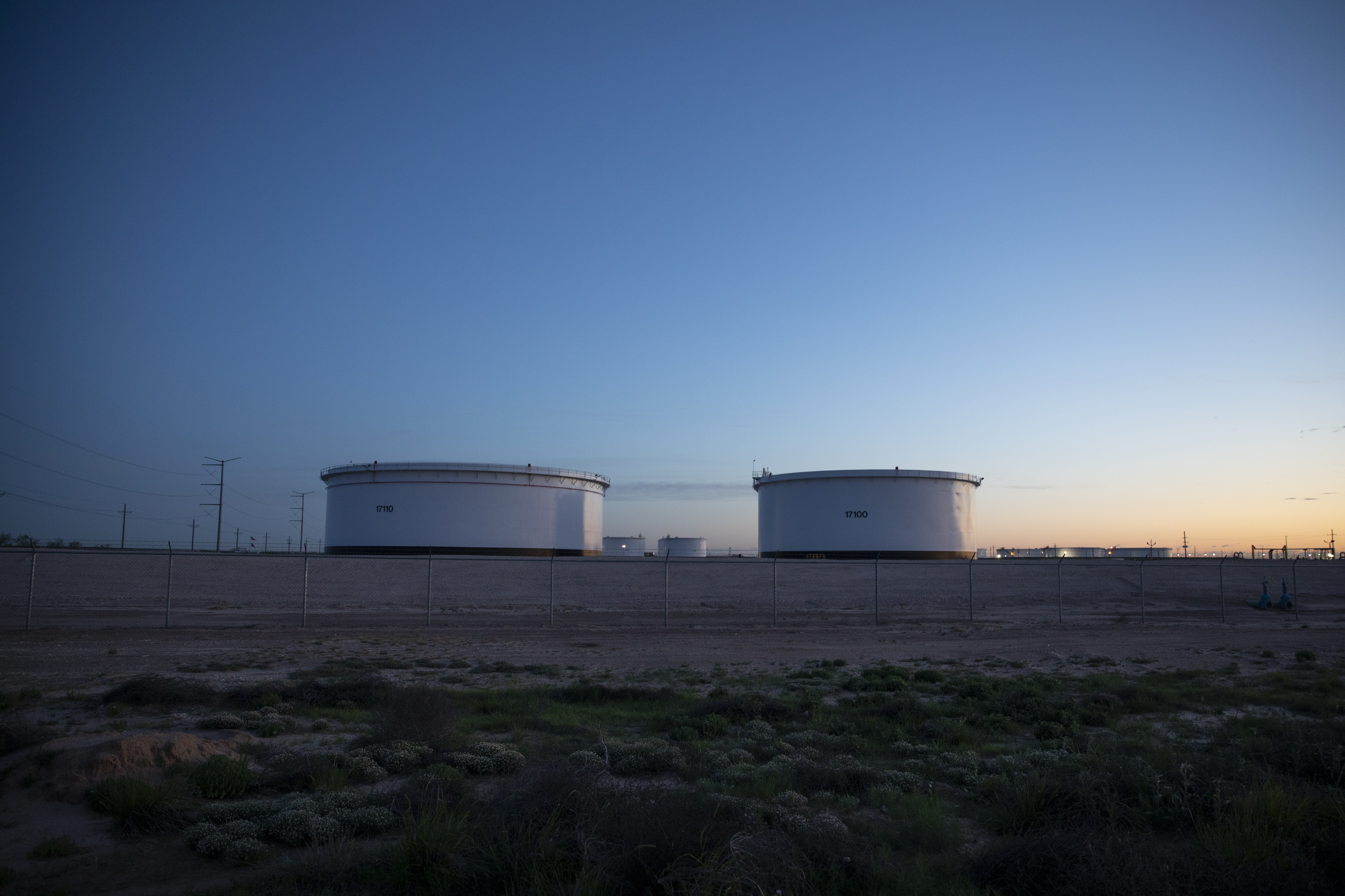 Crude oil storage tanks stand outside Midland, Texas, U.S, on Friday, April 24, 2020. The price for the U.S. benchmark for crude oil, West Texas Intermediate, dropped below zero for the first time in history this month amid a global oil glut. Photographer: Matthew Busch/Bloomberg via Getty Images