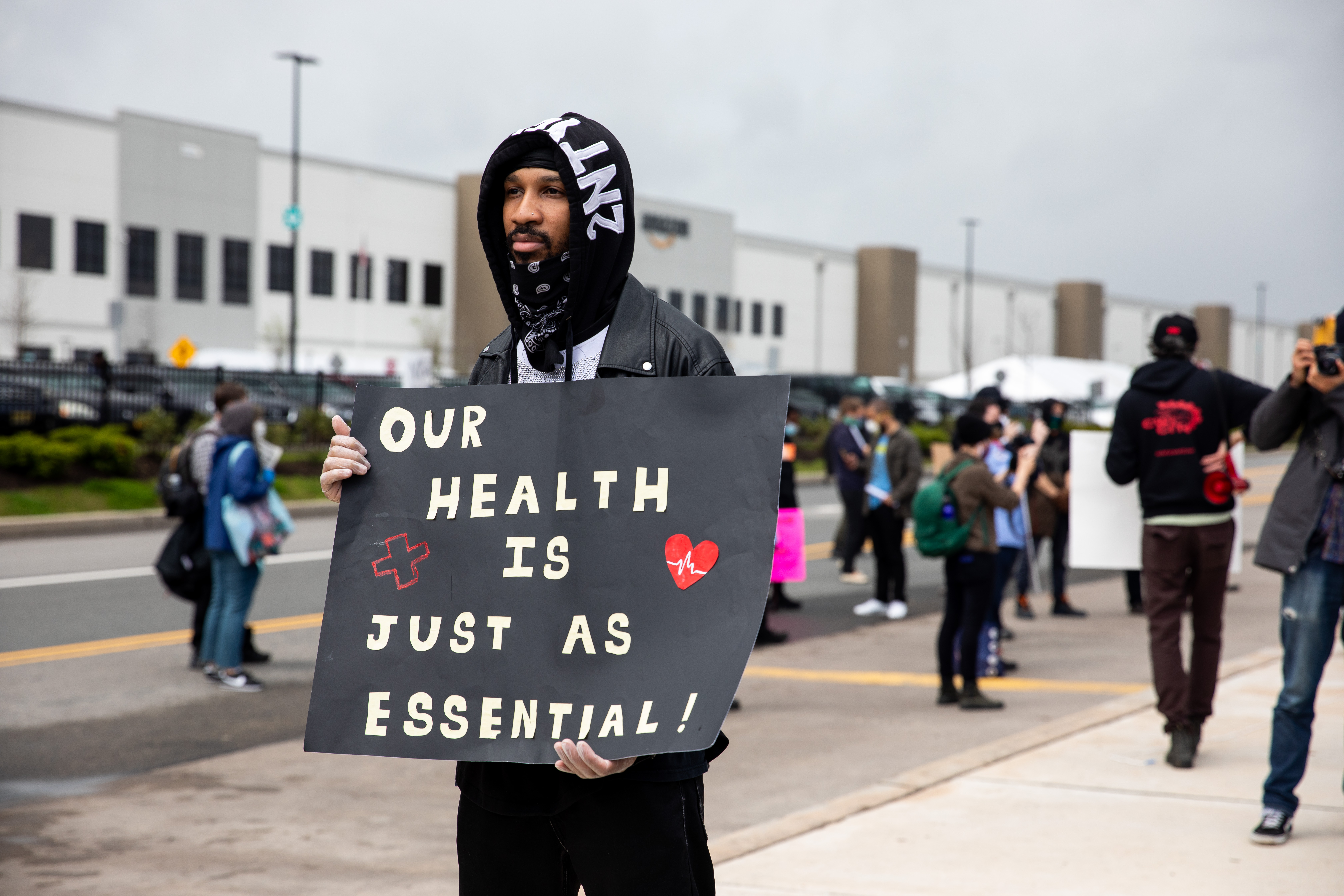 Chris Smalls, a fired Amazon fulfillment center employee, center, protest outside an Amazon.com facility in the Staten Island on May 1, 2020.