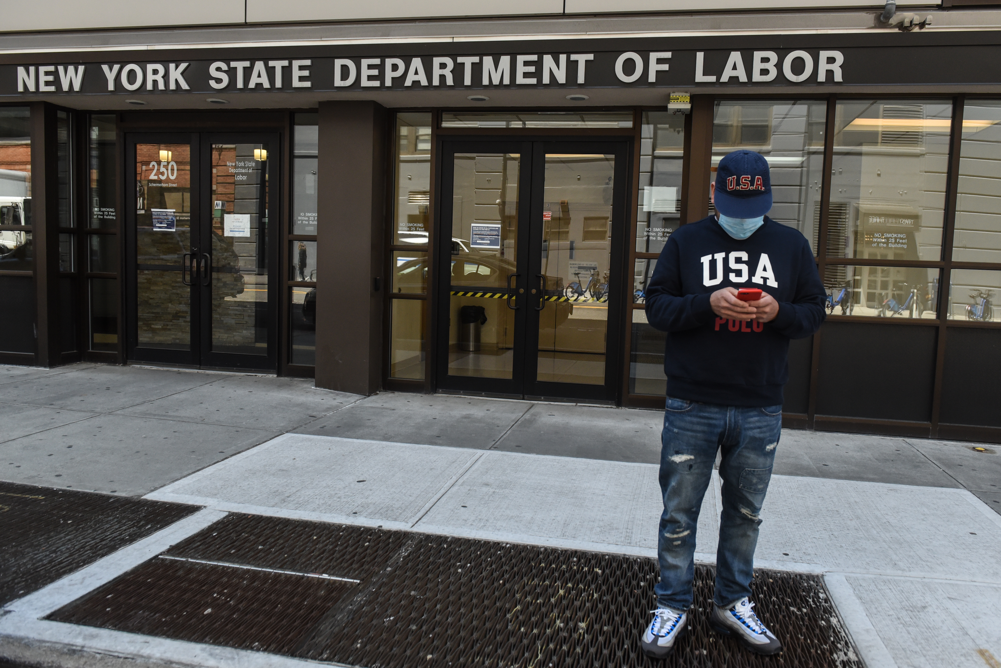 A man stands in front of the closed offices of the New York State Department of Labor on May 7, 2020 in the Brooklyn borough in New York City. 33 million Americans have filed for unemployment insurance in the past two months, a period in which the equities markets have rallied. Wire photography: Stephanie Keith—Getty Images