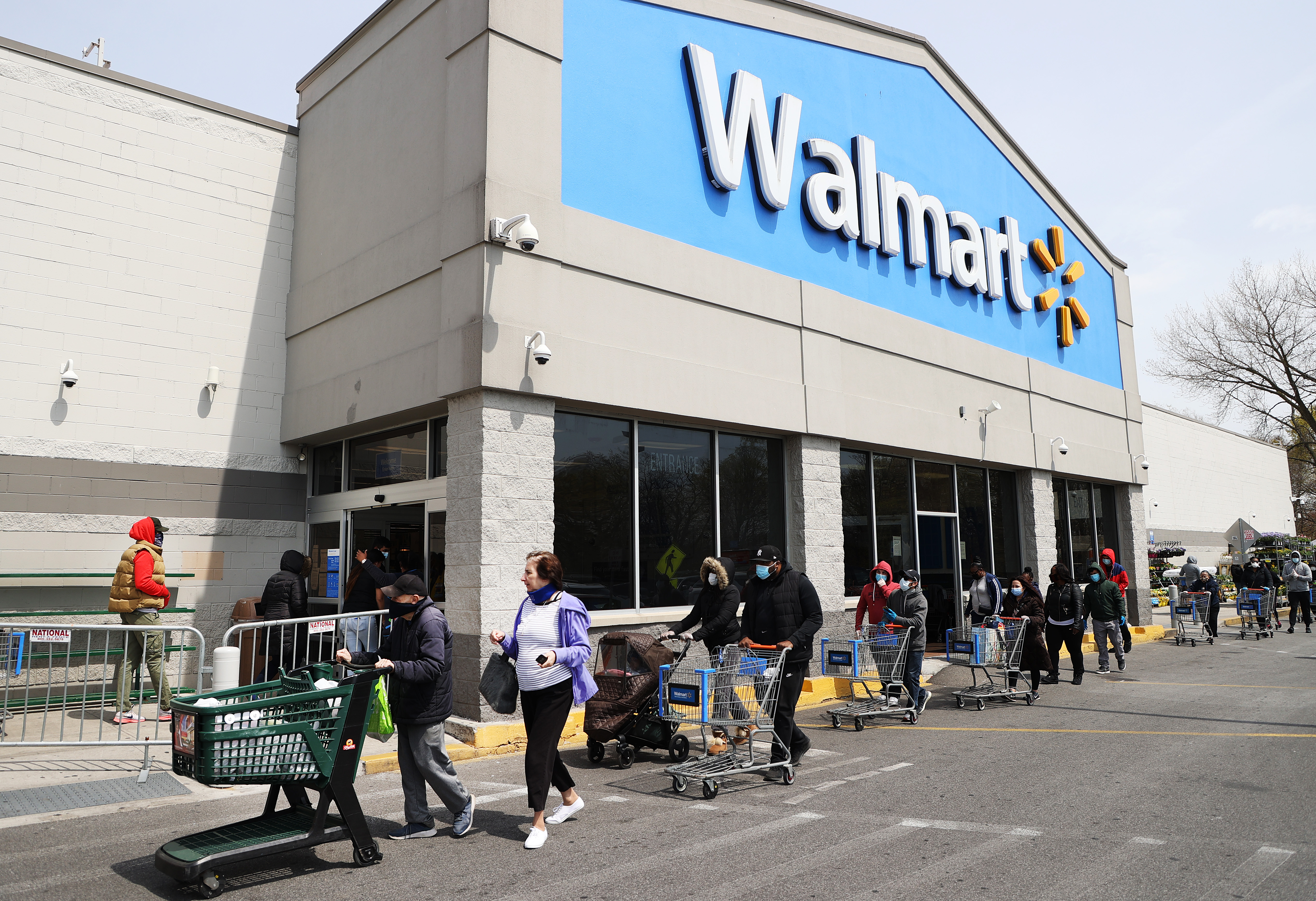 UNIONDALE, NEW YORK - APRIL 17: People wearing masks and gloves wait to enter a Walmart on April 17, 2020 in Uniondale, New York. The World Health Organization declared coronavirus (COVID-19) a global pandemic on March 11th. (Photo by Al Bello/Getty Images)