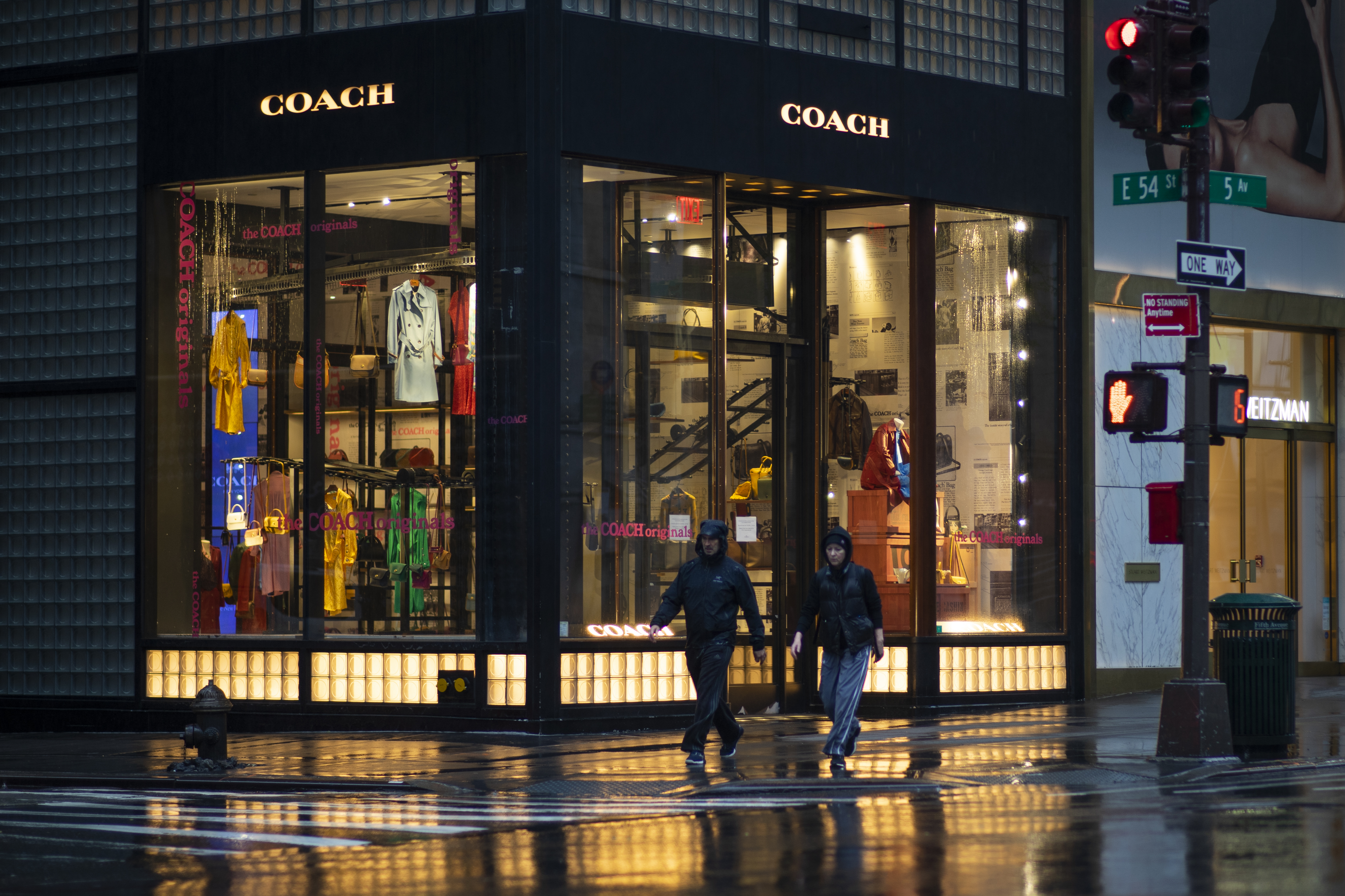 NEW YORK, NY - APRIL 30: People walk by a Coach store on April 30, 2020 in New York City. Coach's parent company Tapestry reported that sales were down nearly 20 percent because of store closures due to the coronavirus (COVID-19) pandemic worldwide. (Photo by Eduardo MunozAlvarez / VIEWpress via Getty Images)