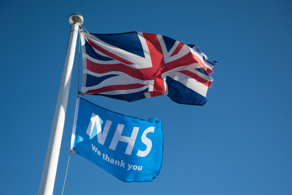 "We Thank You NHS" flag and a Union Jack fly together against a clear blue sky on May 05, 2020 in Benfleet, England. The country continued quarantine measures intended to curb the spread of Covid-19, but the infection rate is falling, and government officials are discussing the terms under which it would ease the lockdown. (Photo by John Keeble/Getty Images)