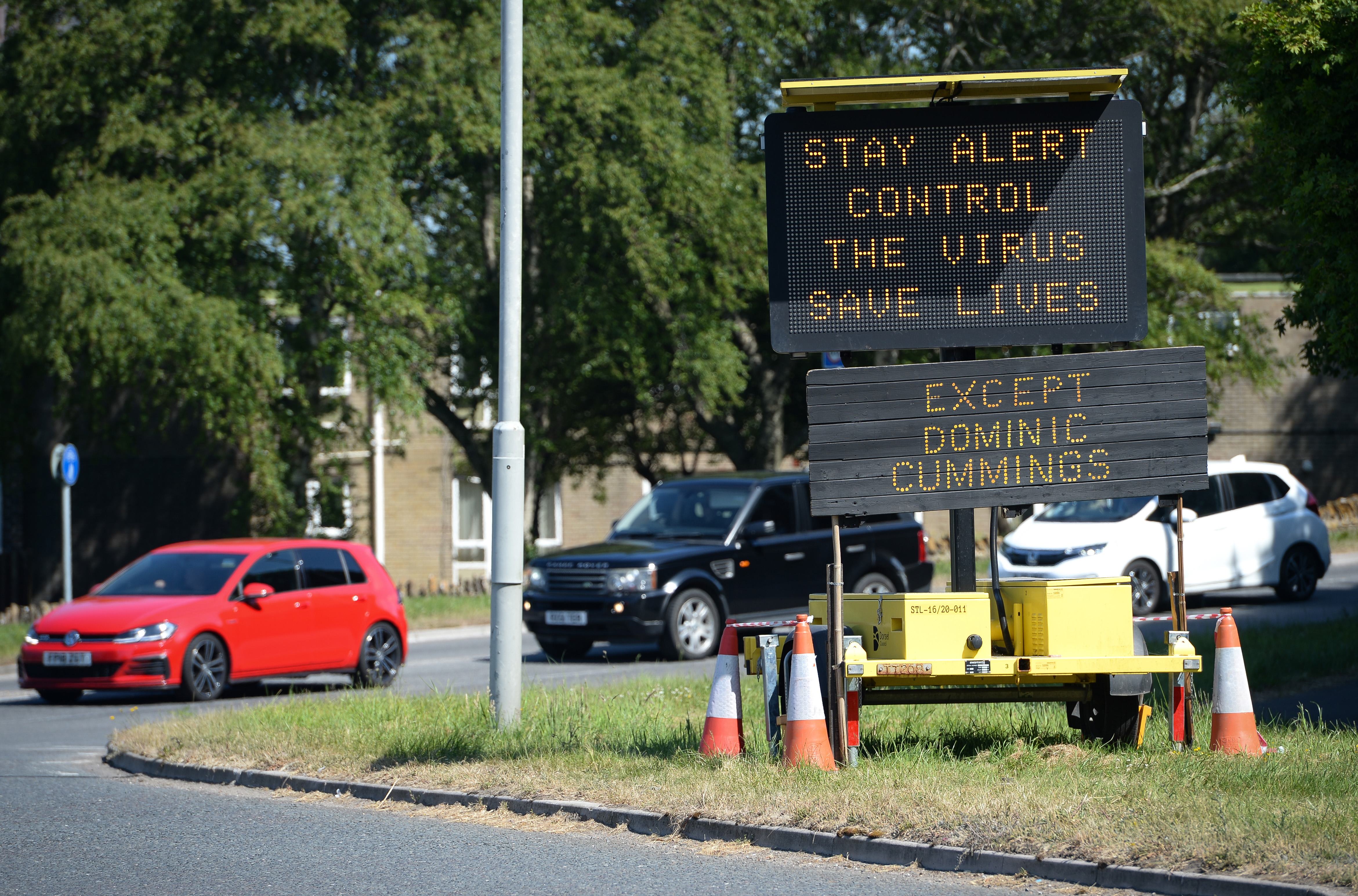 BRIDPORT, ENGLAND - MAY 27: A road sign stating 'Stay Alert, Control the Virus, Save Lives' has an additional sign added by members of the public stating 'Except Dominic Cummings' on May 27, 2020 in Bridport, United Kingdom. The British government continues to ease the coronavirus lockdown by announcing schools will open to reception year pupils plus years one and six from June 1st. Open-air markets and car showrooms can also open from the same date.  (Photo by Finnbarr Webster/Getty Images)