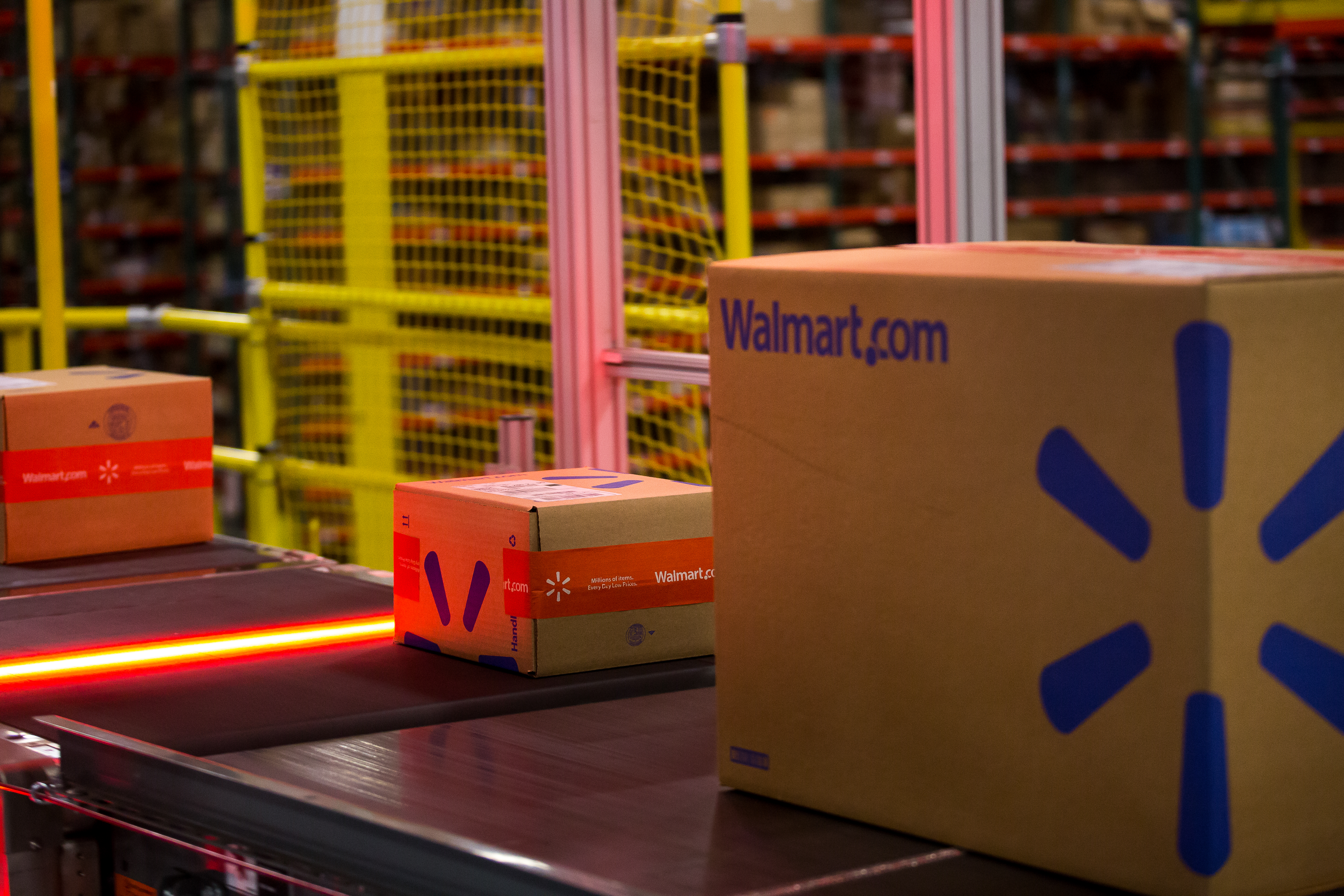 Packages move along a conveyor belt inside a Wal-Mart Stores Inc. fulfillment center in Bethlehem, Pennsylvania, U.S., on Wednesday, March 29, 2017. Wal-Mart Stores Inc. acquired e-commerce startup Jet.com for $3.3 billion in cash and stock. Jet.com Founder and his management team were put in charge of Wal-Mart's entire domestic e-commerce operation, overseeing more than 15,000 employees in Silicon Valley, Boston, Omaha, and its home office in Arkansas. Photographer: Michael Nagle/Bloomberg via Getty Images