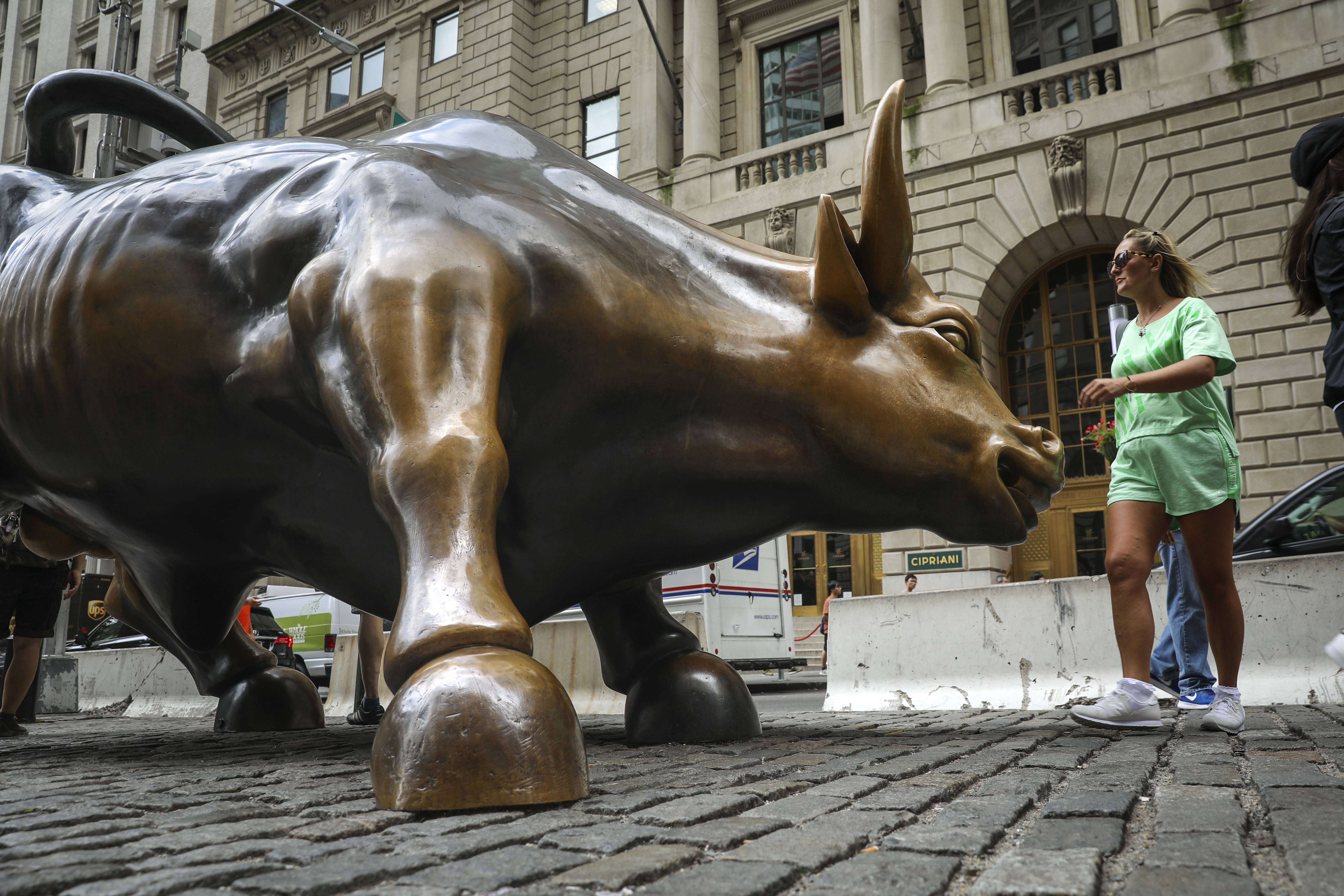 Tourists visit the Wall Street bull statue in the Financial District in New York City. After a March swoon, the stocks rally have been on a major rally, forcing equities analysts to reassess their markets forecasts. Wire photography: Drew Angerer—Getty Images
