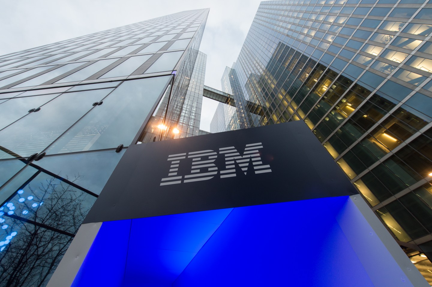 The logo of IBM is seen at the entrance to the Highlight Towers in Munich, Germany, 15 December 2015. Technology corporation IBM opens its worldwide headquarters for its 'Watson IoT' (Internet of Things) division inside the Highlight Towers. Artificial intelligence is to be used to develop new solutions for the IoT.
