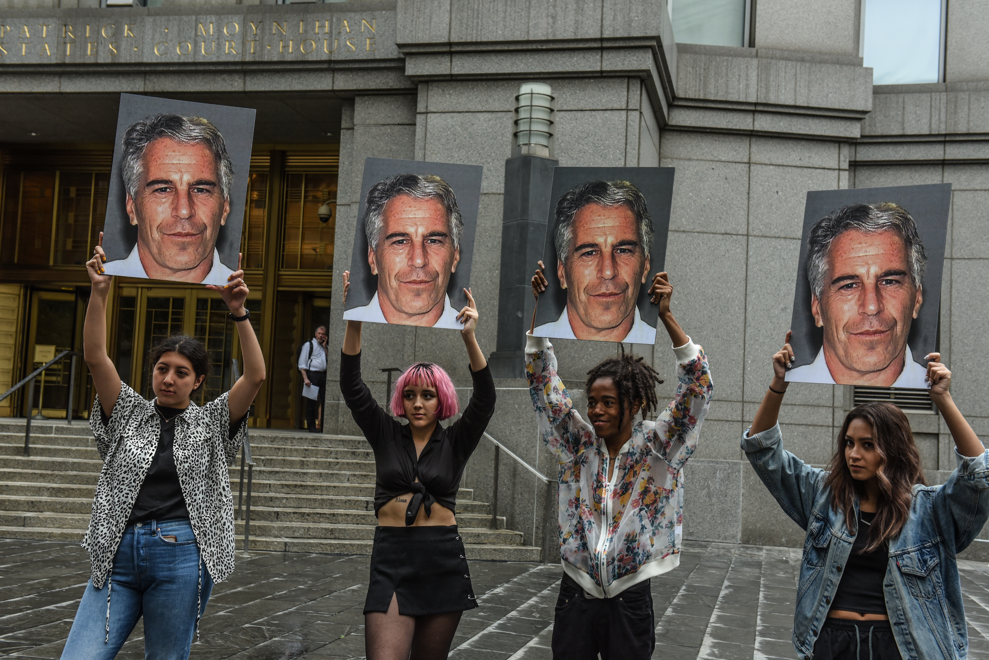 A protest group called "Hot Mess" hold up signs of Jeffrey Epstein in front of the Federal courthouse on July 8, 2019 in New York City. According to reports, Epstein will be charged with one count of sex trafficking of minors and one count of conspiracy to engage in sex trafficking of minors. Stephanie Keith—Getty Images