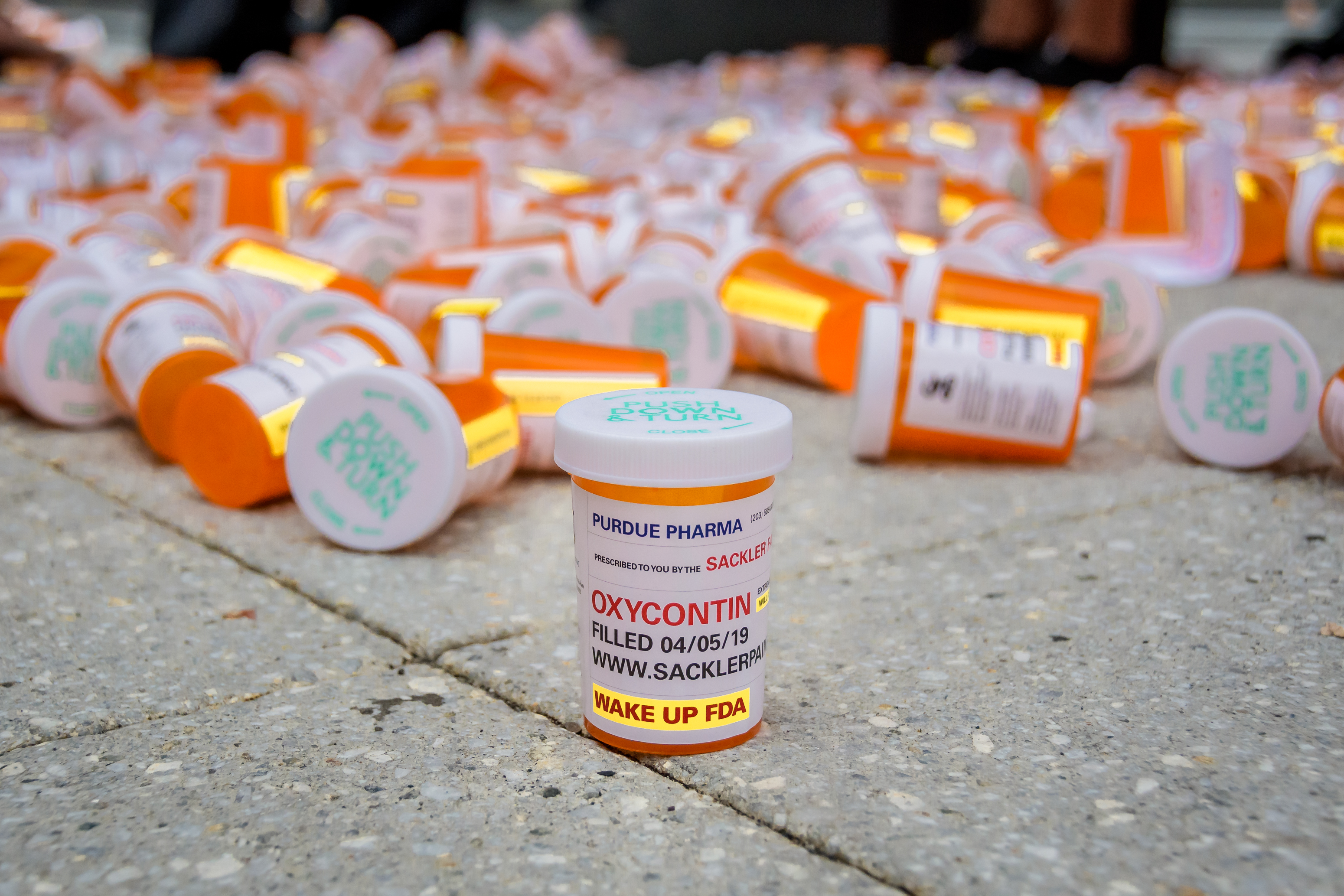 Members of P.A.I.N. (Prescription Addiction Intervention Now) and Truth Pharm staged a protest on September 12, 2019 outside Purdue Pharma headquarters in Stamford, over their recent controversial opioid settlement. Participants dropped hundreds prescription bottles of OxyContin while holding tombstones with the names of opioids casualties and banners reading "Shame on Sackler" and "200 Dead Each Day". Erik McGregor—LightRocket via Getty Images