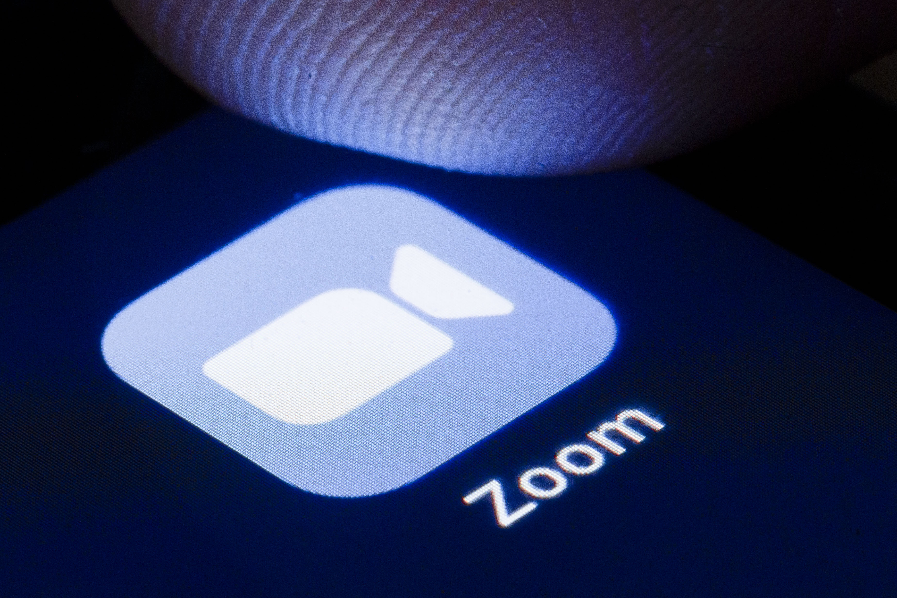 BERLIN, GERMANY - APRIL 22: The logo of the software for video conferences Zoom is shown on the display of a smartphone on April 22, 2020 in Berlin, Germany. (Photo by Thomas Trutschel/Photothek via Getty Images)