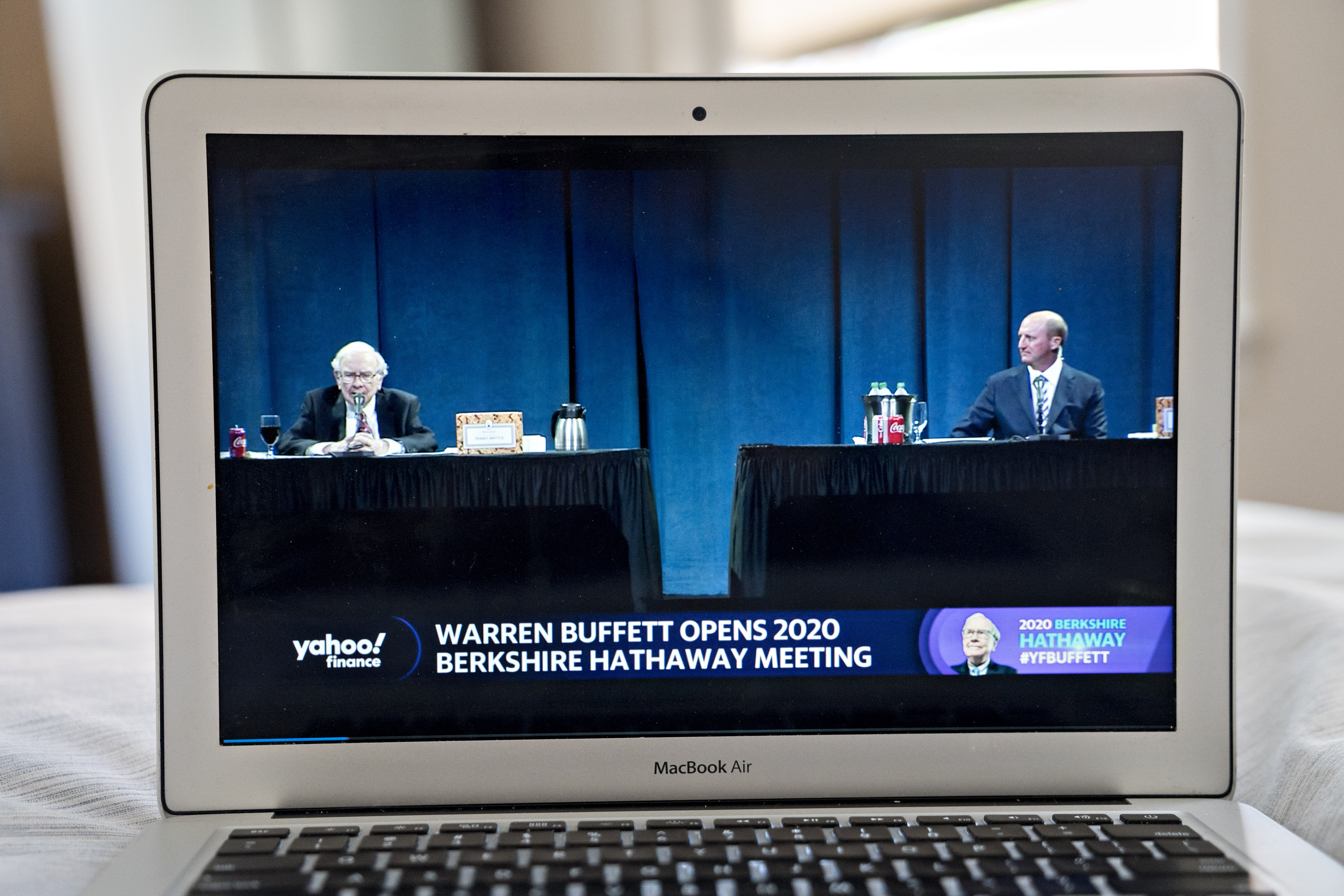 Warren Buffett and Greg Abel listen during the virtual Berkshire Hathaway annual shareholders meeting seen on a laptop computer in Arlington, Va., on May 4, 2020. The coronavirus pandemic has forced most companies to either shelve or conduct their AGMs virtually this year, to the displeasure of activist shareholders.