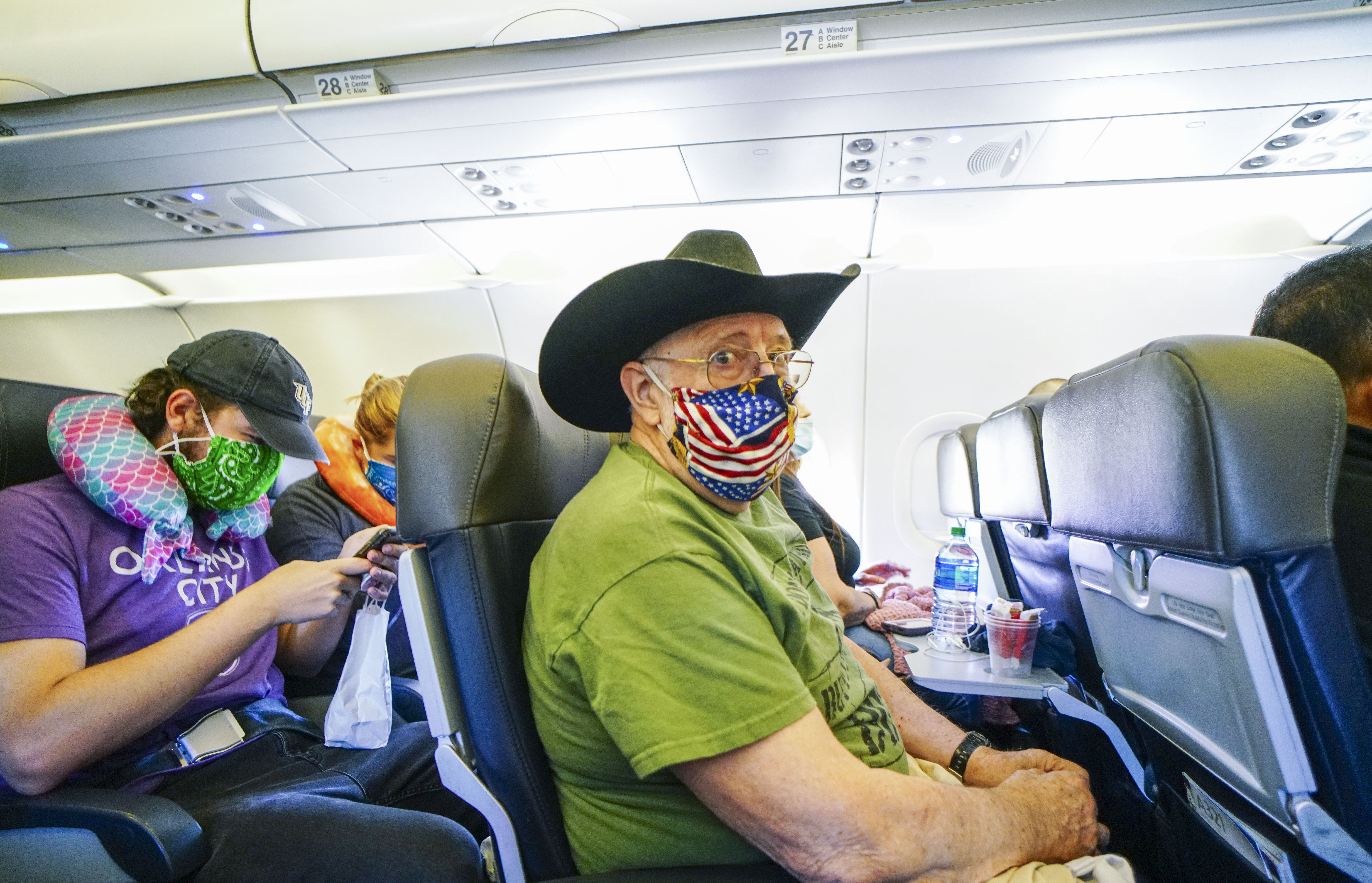 SAN DIEGO, CA - MAY 20: Passengers onboard an American Airlines flight to Charlotte, NC at San Diego International Airport on May 20, 2020 in San Diego, California. Air travel is down as estimated 94 percent due to the coronavirus (COVID-19) pandemic, causing U.S. airlines to take a major financial hit with losses of $350 million to $400 million a day and nearly half of major carriers airplanes are sitting idle. (Photo by Sandy Huffaker/Getty Images)