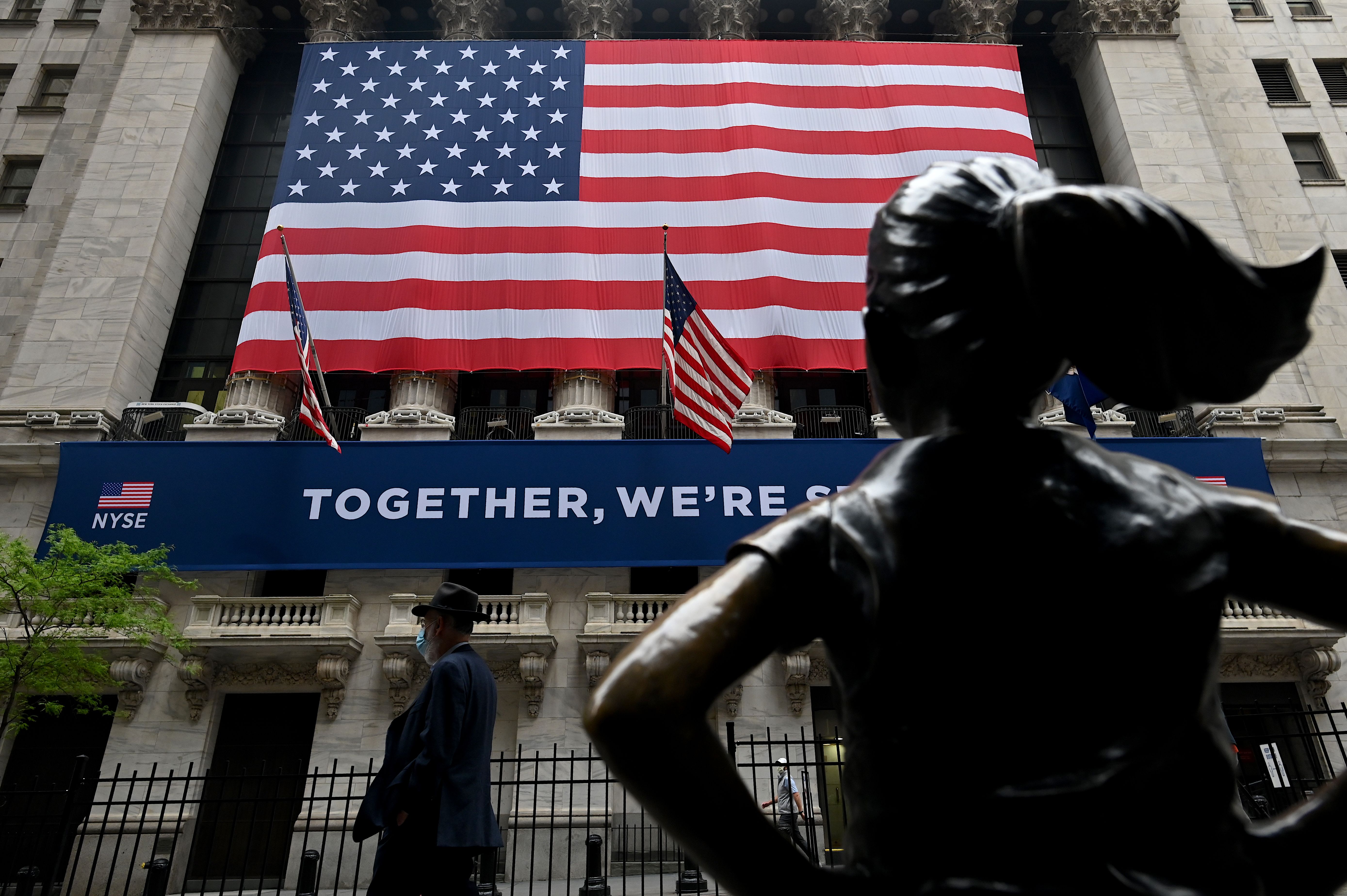 A man passes the building before the opening bell at the New York Stock Exchange last week on Wall Street in New York City. The benchmark S&P 500 is up more than 37% over the past 50 trading sessions, its best bull run ever. Wire photography: Johannes Eisele—AFP via Getty Images