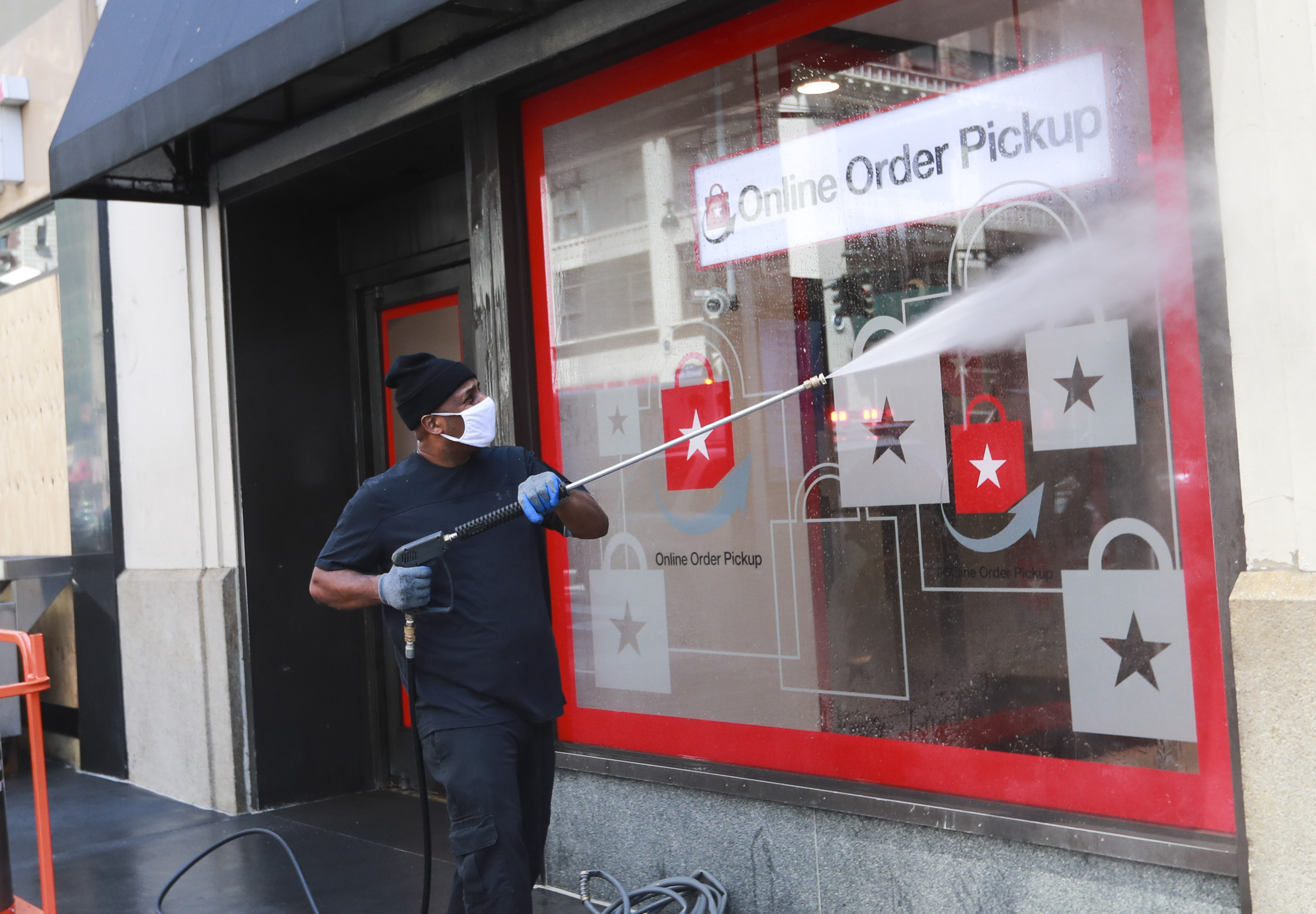 NEW YORK, June 8, 2020 -- A worker cleans the window of Macy's online order pickup office in Manhattan of New York, the United States, June 8, 2020. After nearly three months of lockdown, New York City entered the first phase of reopening on Monday, 100 days since the city reported its first COVID-19 case.( Photo by Wang Ying/Xinhua via Getty) (Xinhua/Wang Ying via Getty Images)