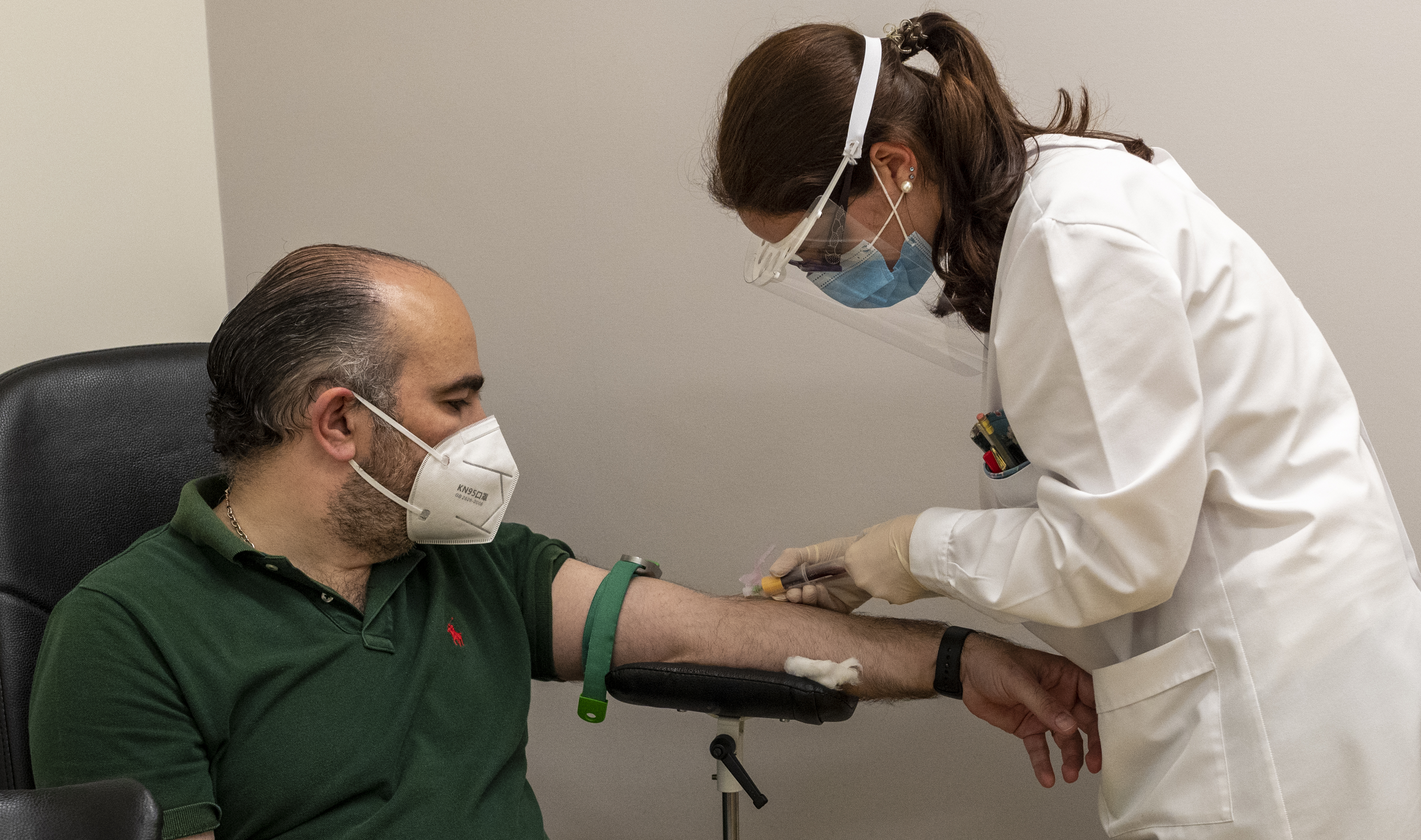 Deputy Mayor Miguel Pinto Luz wears a protective mask while a health technician wearing protective visor, mask and gloves takes a blood sample for a serological test in Joaquim Chaves laboratories during the COVID-19 Coronavirus pandemic on May 21, 2020 in Cascais, Portugal. Cascais is the first Portuguese municipality, and one of the first worldwide, testing its entire population with serological tests, developed by the multinational Roche Diagnostics, able to detect the presence of antibodies and immune response against SARSCoV2 in the more than 200,000 inhabitants of Cascais.  Horacio Villalobos—Corbis via Getty Images