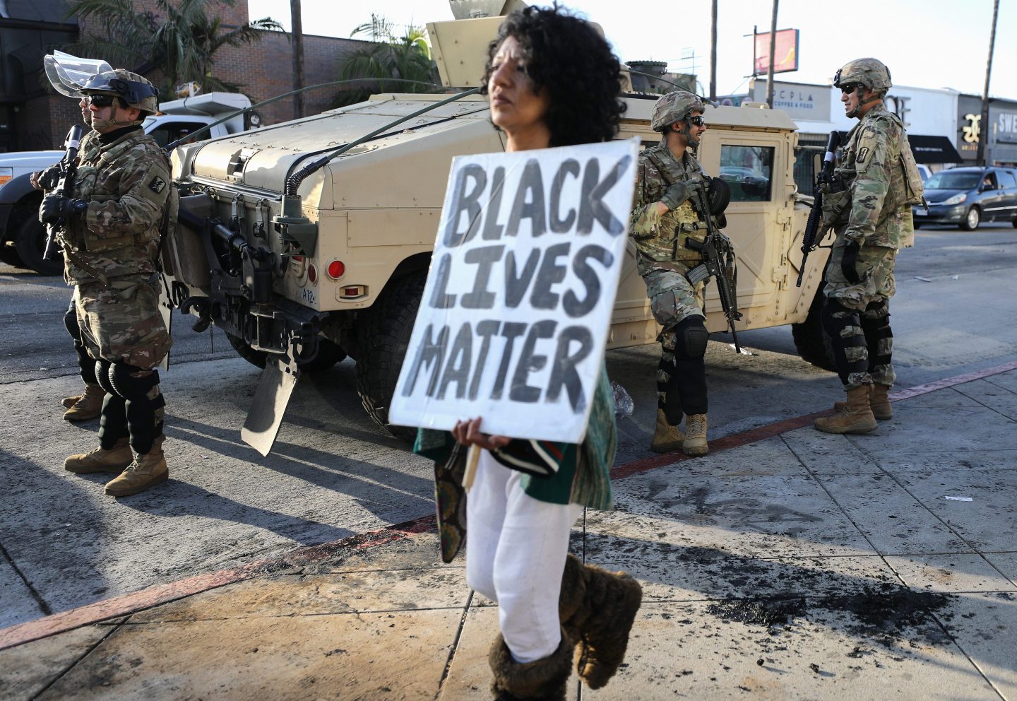 woman carries black lives matter sign